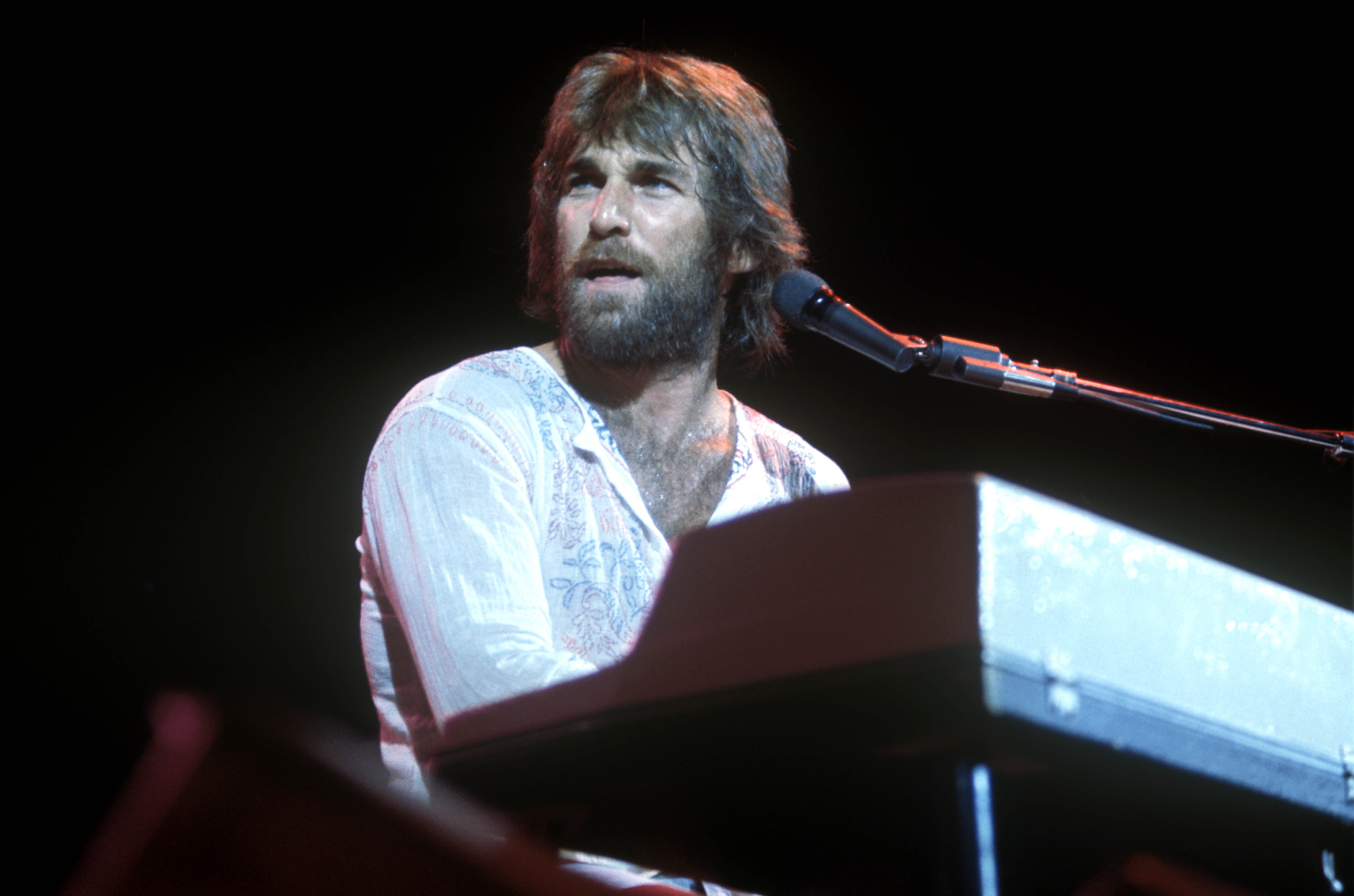 Dennis Wilson of the Beach Boys performing on stage, keyboards