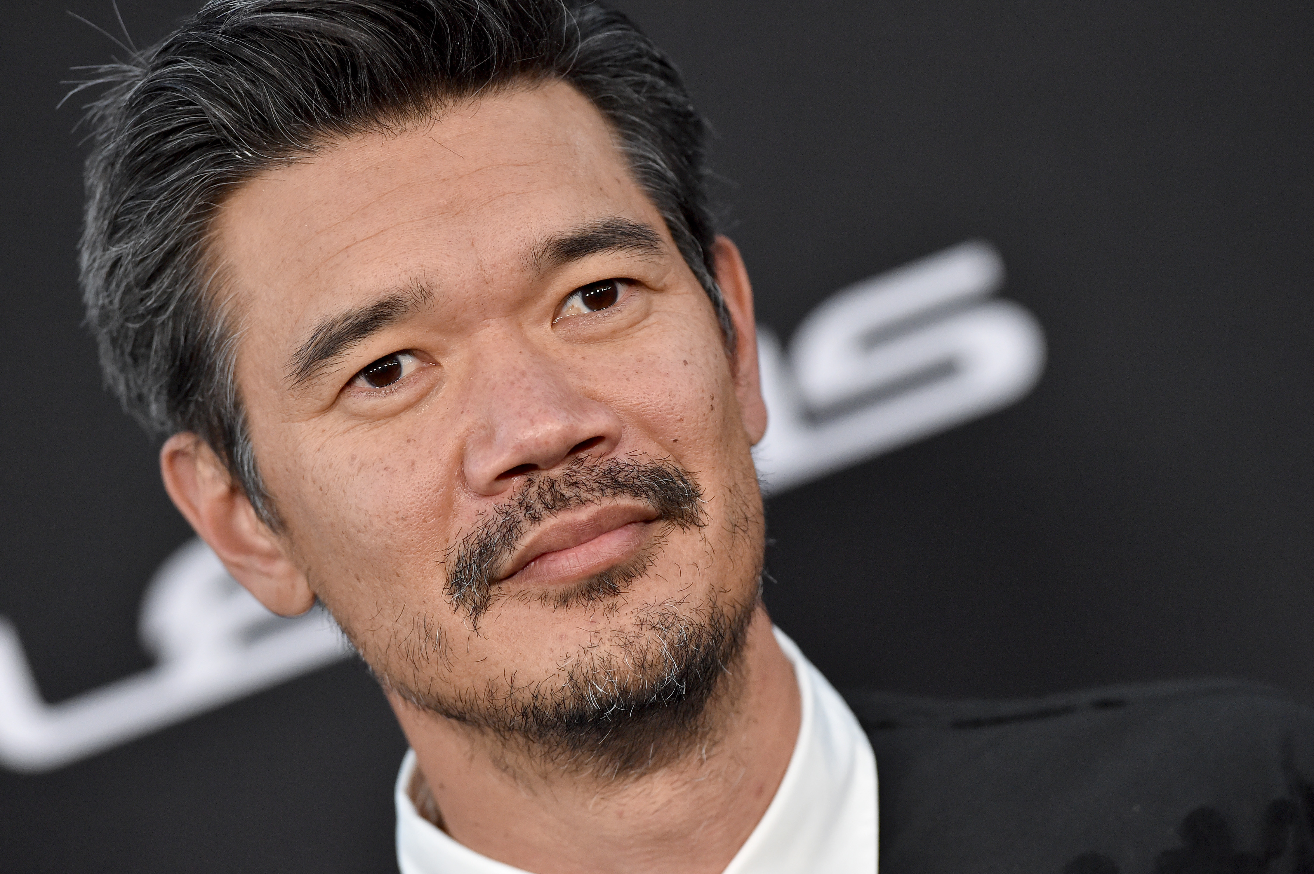 Destin Daniel Cretton, who will direct 'Avengers: The Kang Dynasty,' wears a black suit over a white collared shirt.