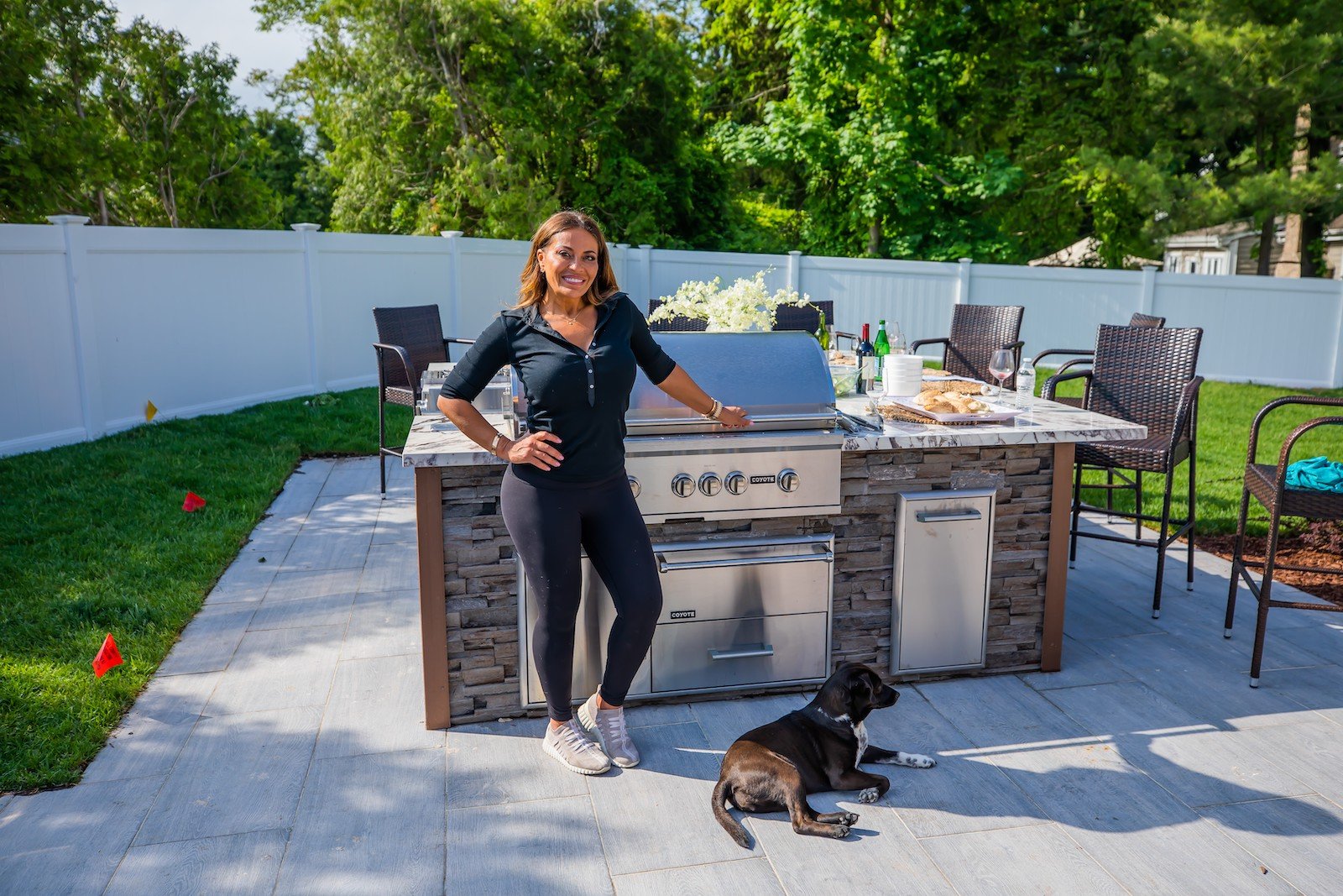 Dolores Catania from 'RHONJ' stands next to her outdoor kitchen in her backyard 