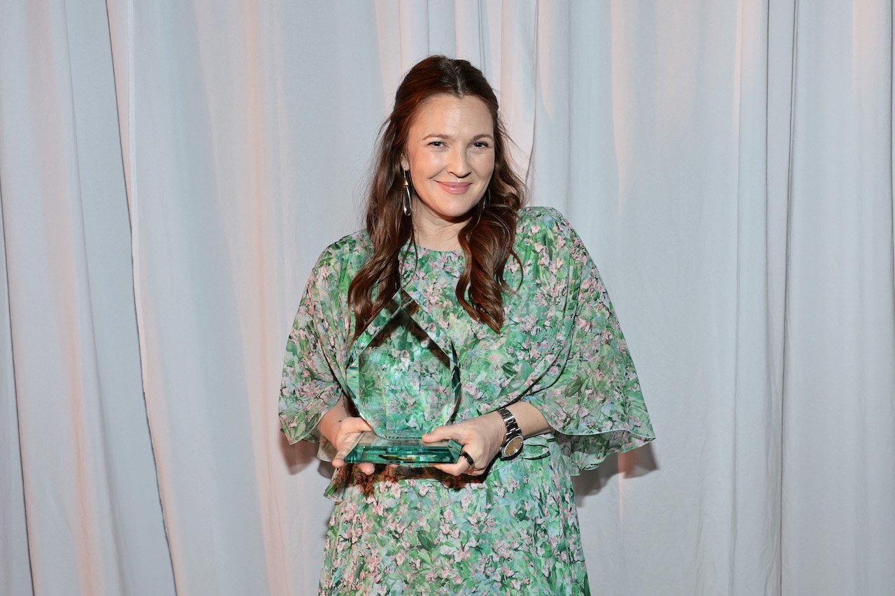Drew Barrymore, pictured holding an award in 2022, is committed to a sustainable lifestyle