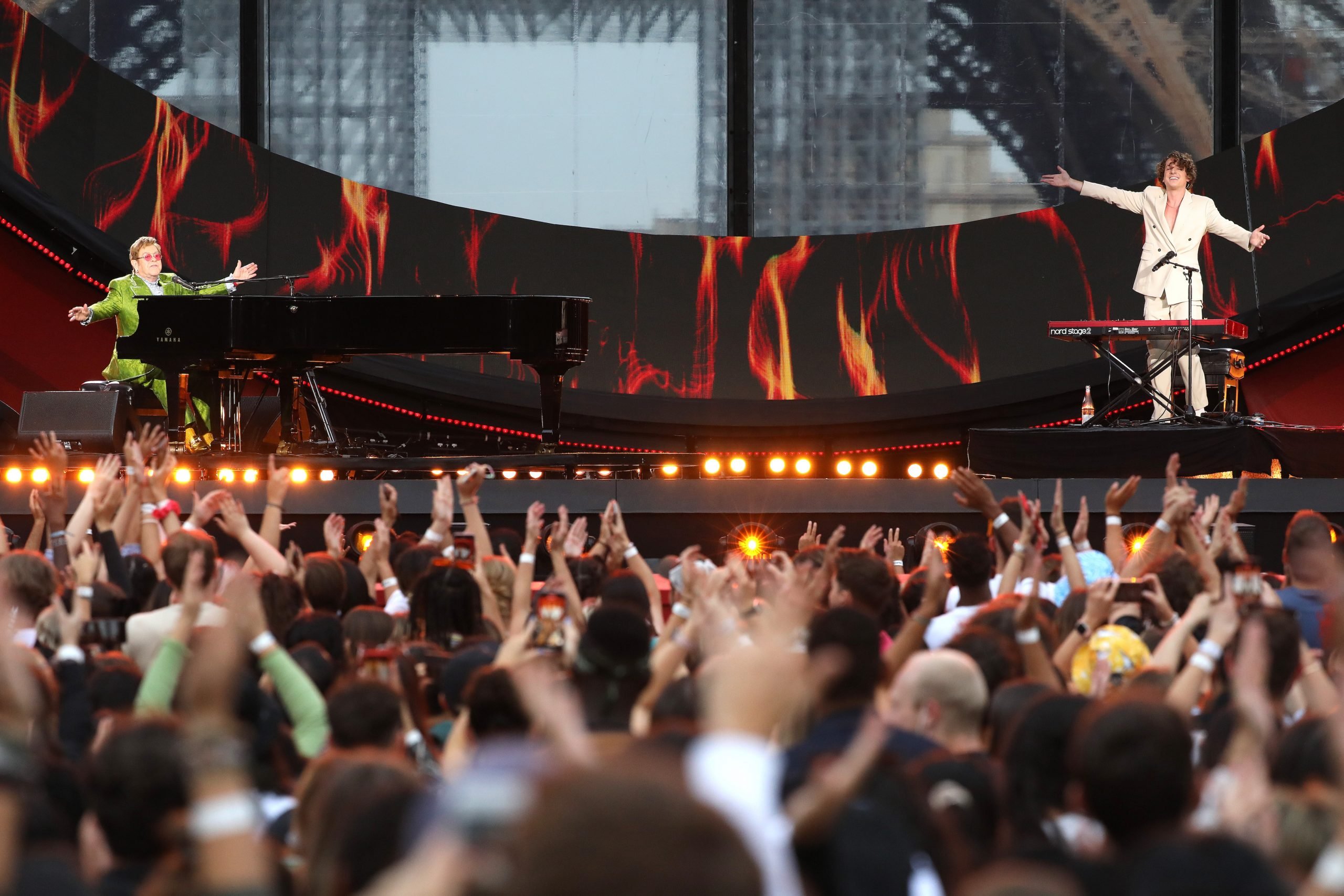 Elton John and Charlie Puth perform on stage during Global Citizen Live