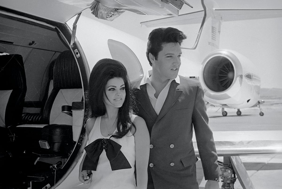 Elvis and Priscilla Presley Posing near an airplane