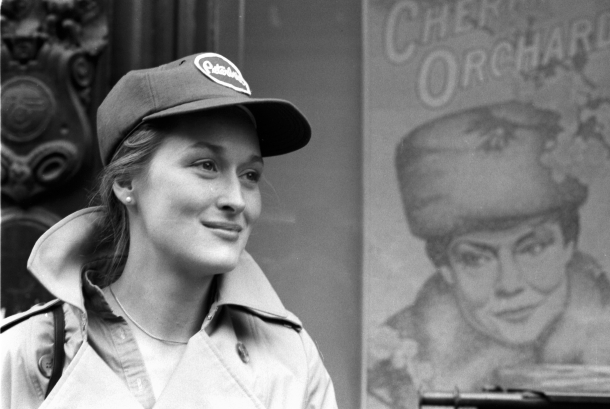 Emmy Award winner Meryl Streep wearing a baseball cap and a coat with a smile on her face