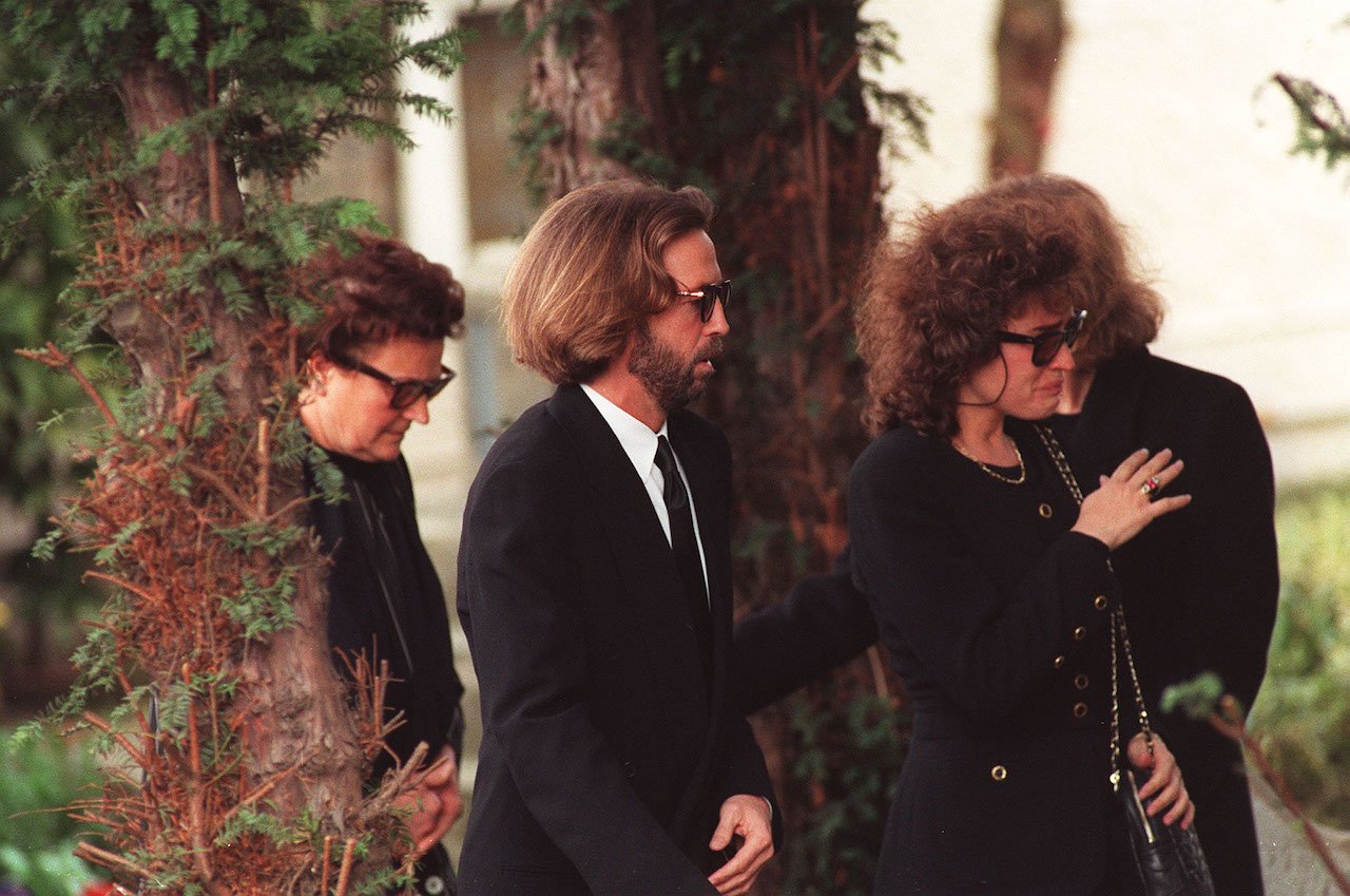 Eric Clapton, shown at his son's funeral with his ex-girlfriend, spent time in solitude after tragedy