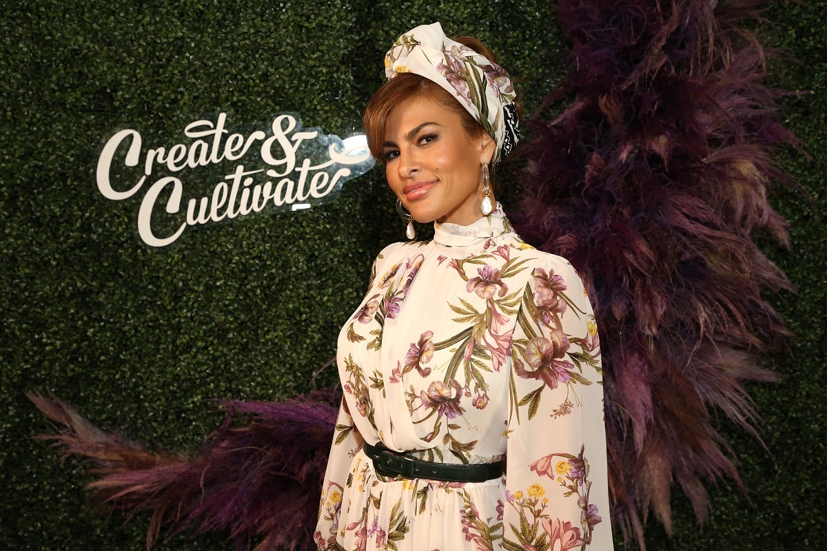 Eva Mendes smirking while wearing a white dress.