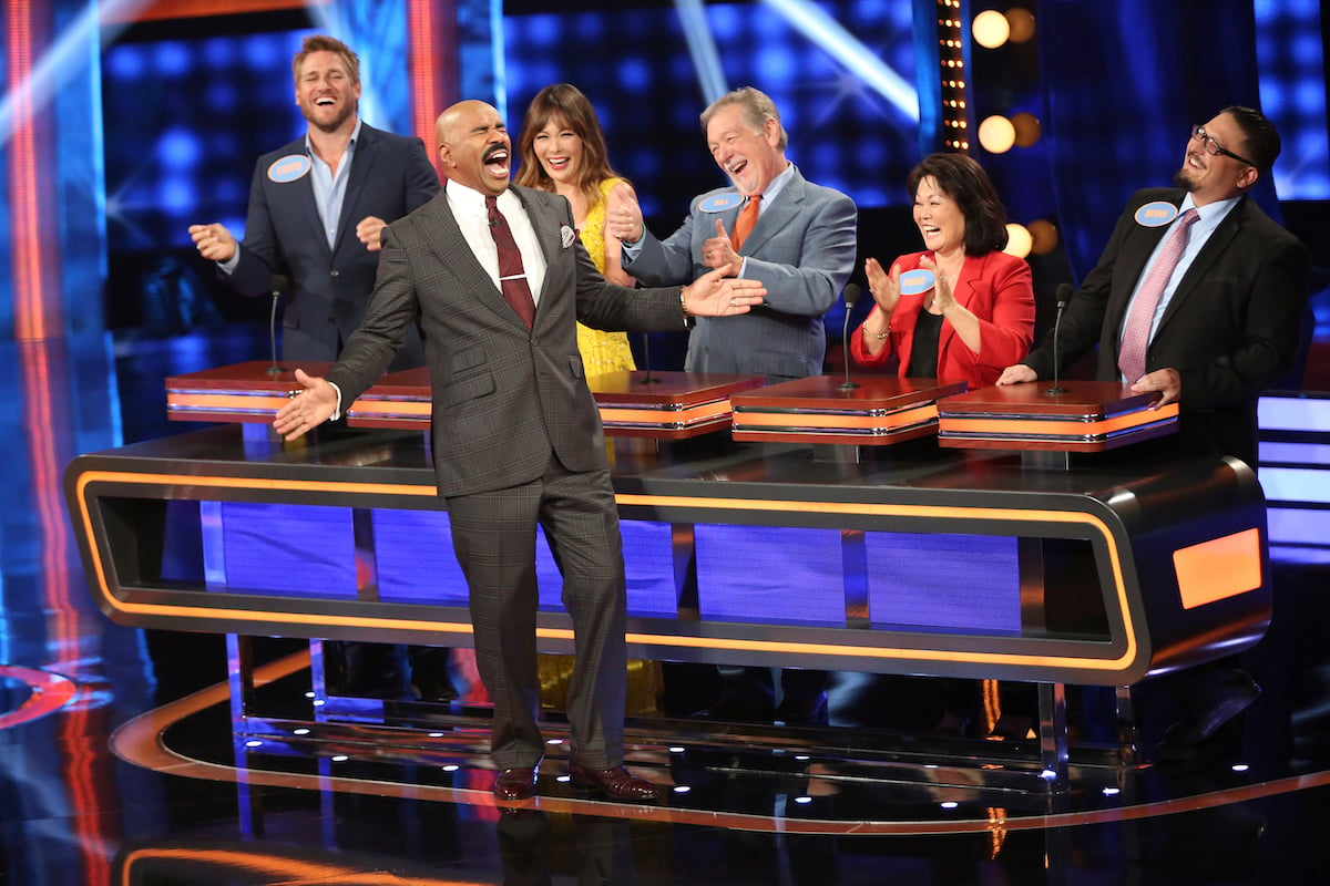 Steve Harvey laughs out loud as contestants watch on Family Feud