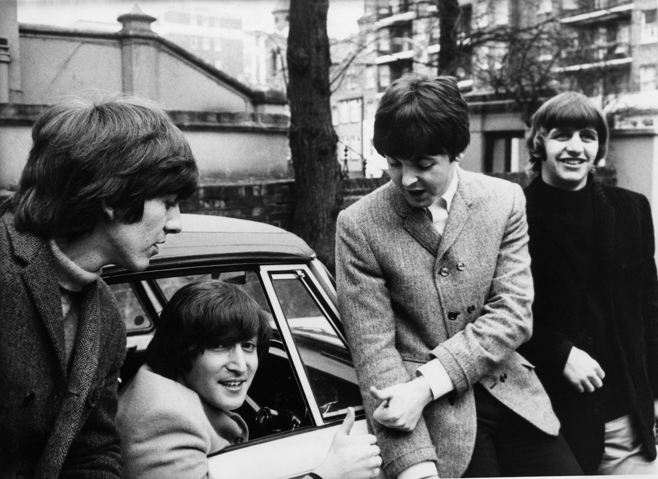 George Harrison, John Lennon, Paul McCartney, and Ringo Starr of The Beatles following John's successful drivers license exam in 1965.