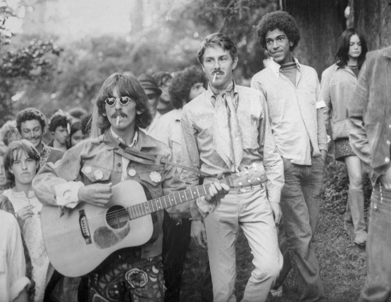 George Harrison playing guitar at Haight-Ashbury in 1967.