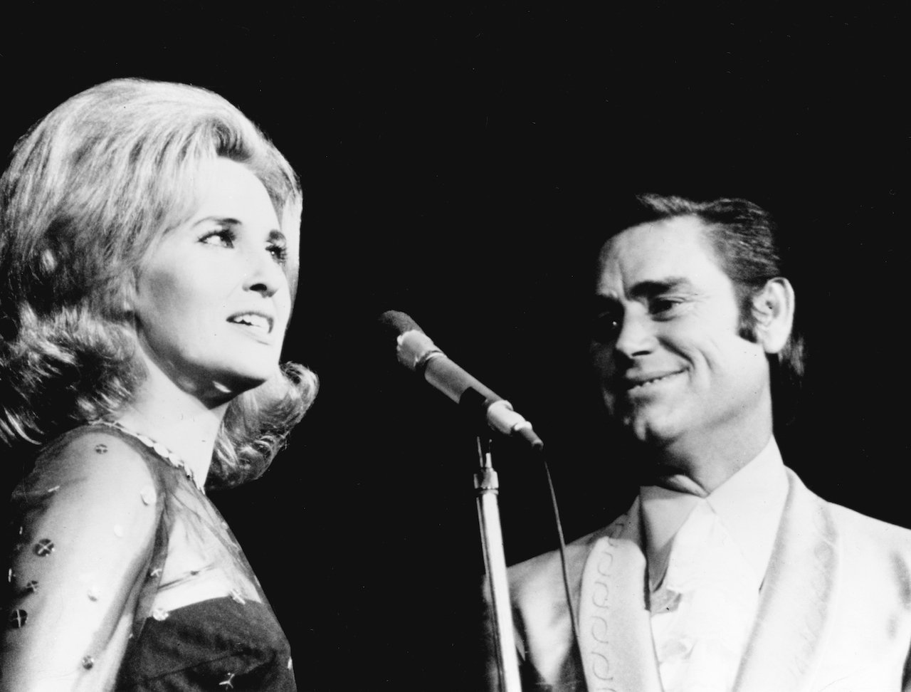 George Jones had a tumultuous marriage with Tammy Wynette, pictured performing together c. 1970