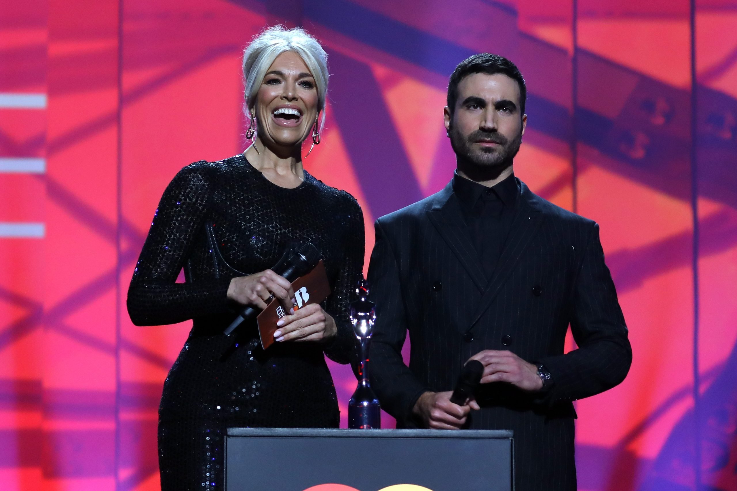 Ted Lasso actors Hannah Waddingham and Brett Goldstein present the award for Song of the Year at the 2022 BRIT awards