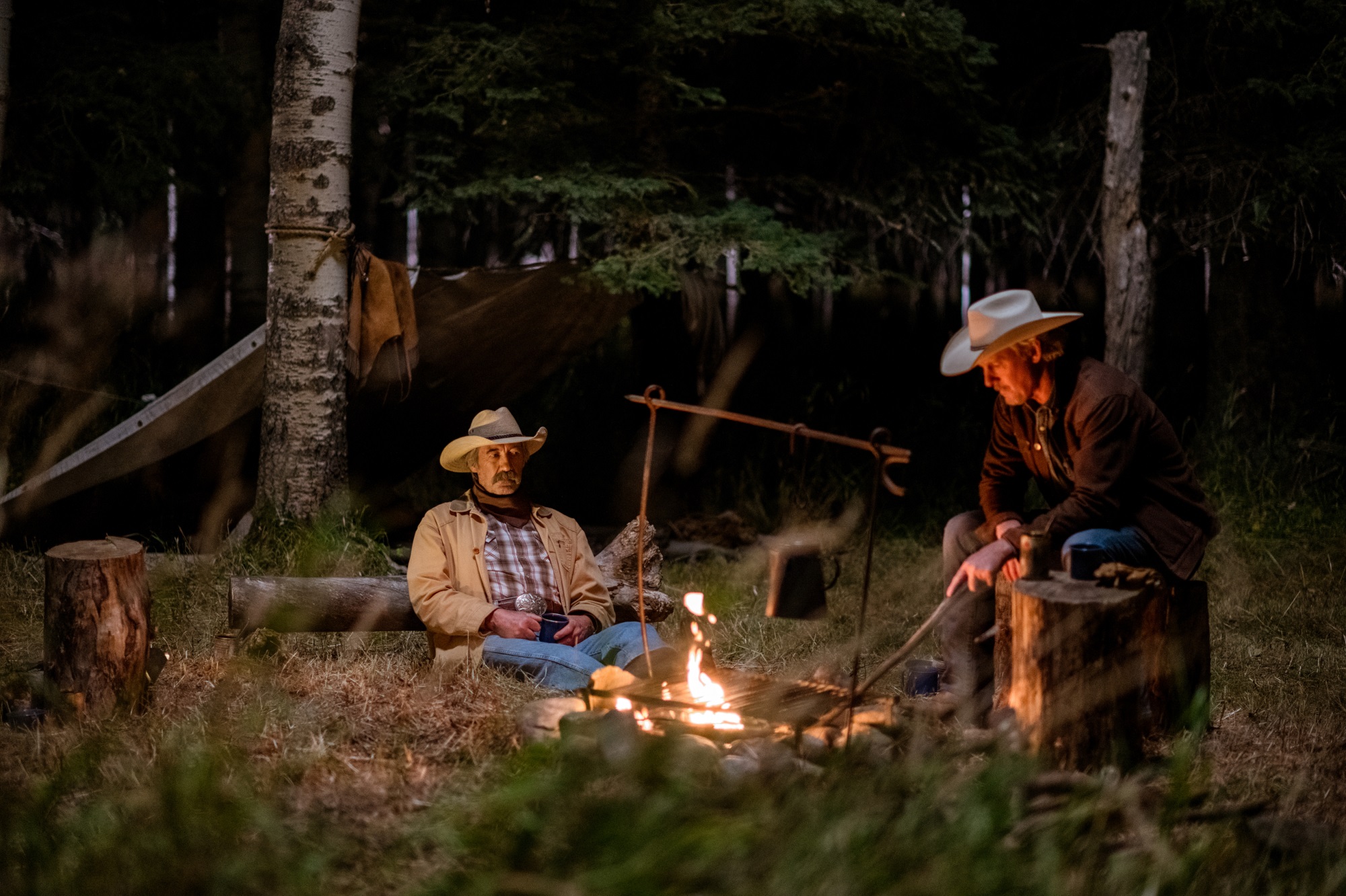Jack and Tim sit near a campfire in 'Heartland'