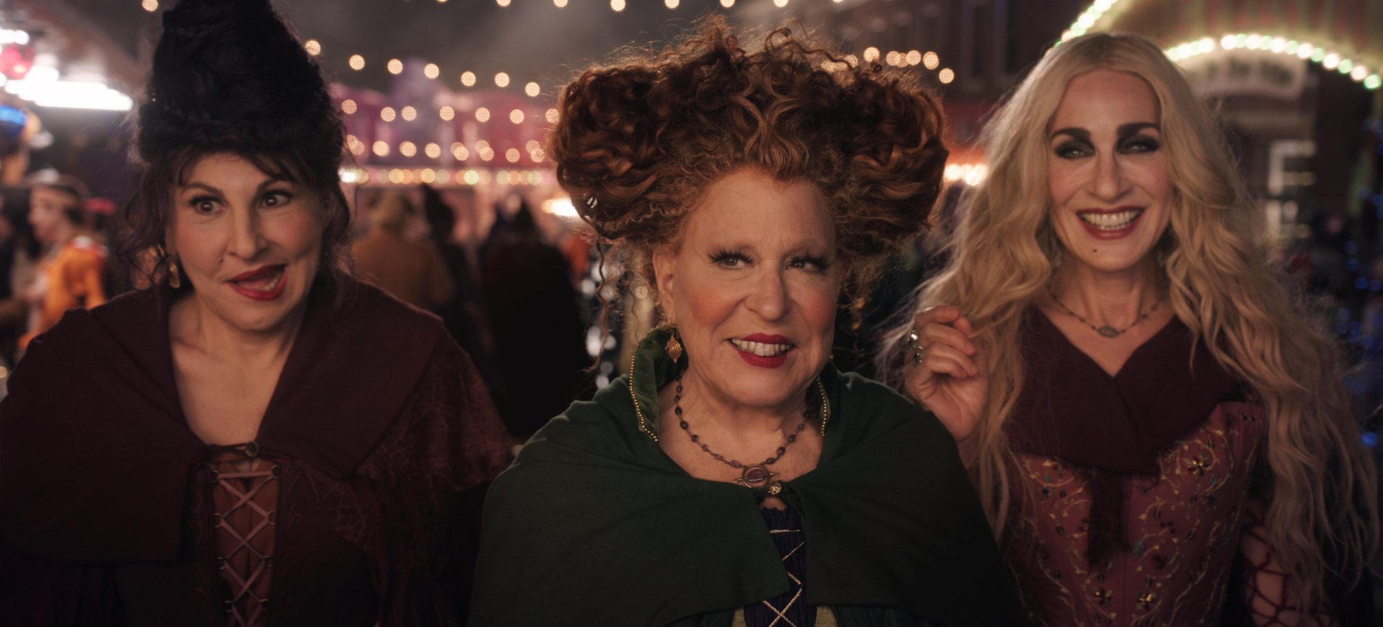 'Hocus Pocus 2' Kathy Najimy as Mary, Bette Midler as Winifred, and Sarah Jessica Parker as Sarah, which fans are boycotting over tweets, wearing witch costumes and smiling in front of a crowd of people