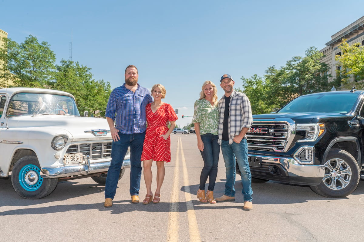 Ben and Erin Napier and Jenny and Dave Marrs from 'Home Town Takeover' Season 2 standing in front of pickup trucks