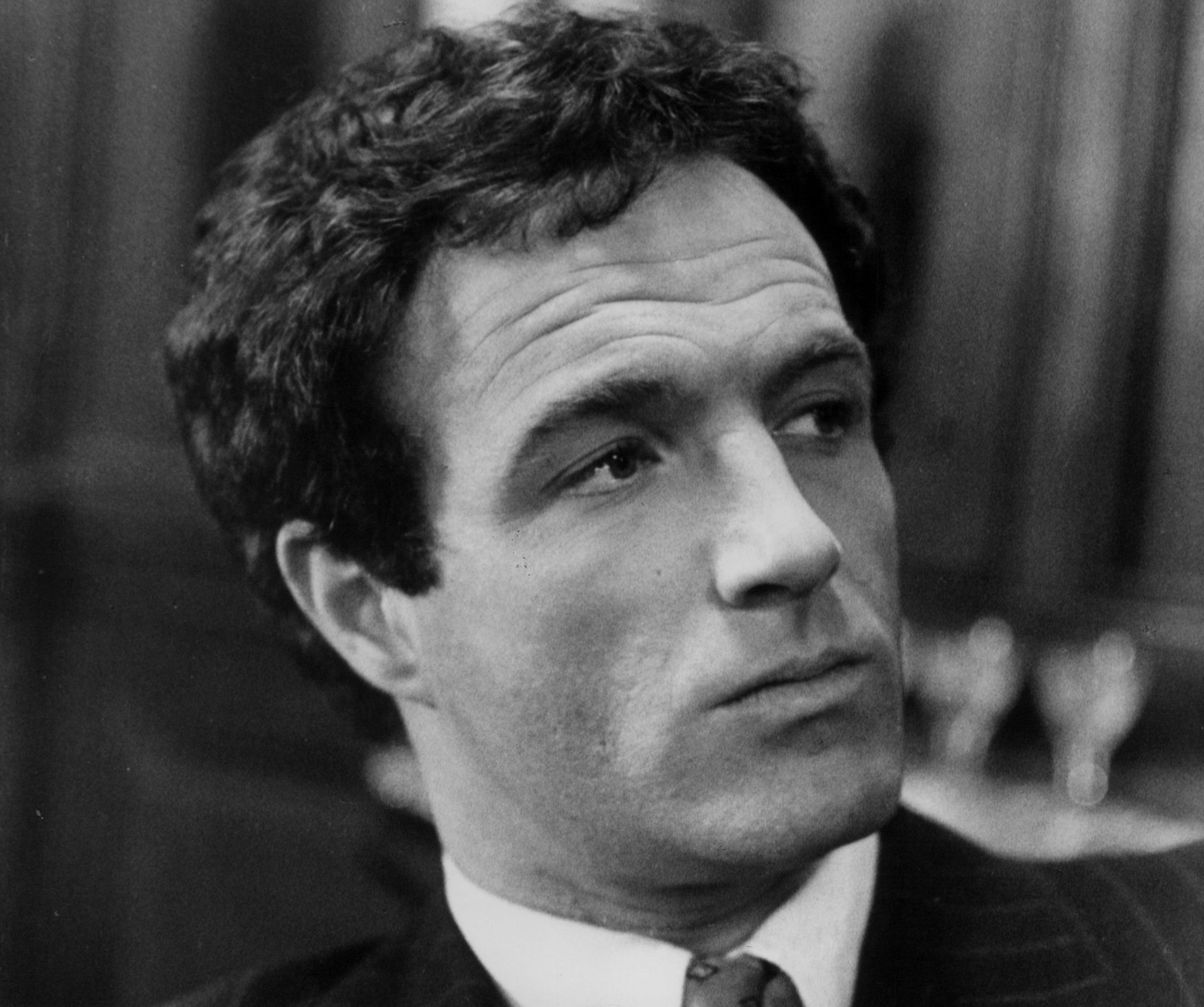 A black and white picture of James Caan wearing a suit in 'The Godfather.'