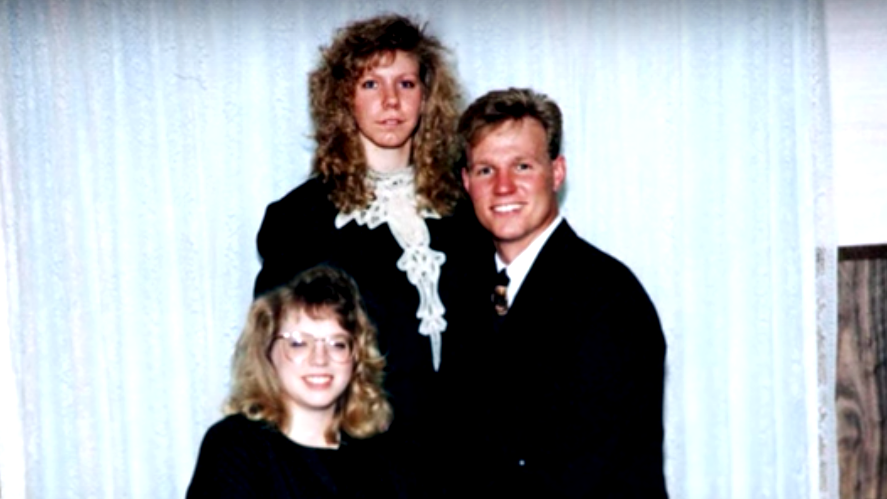 Meri Brown stands behind her husband, Kody Brown and his new wife, Janelle Brown on their wedding day.