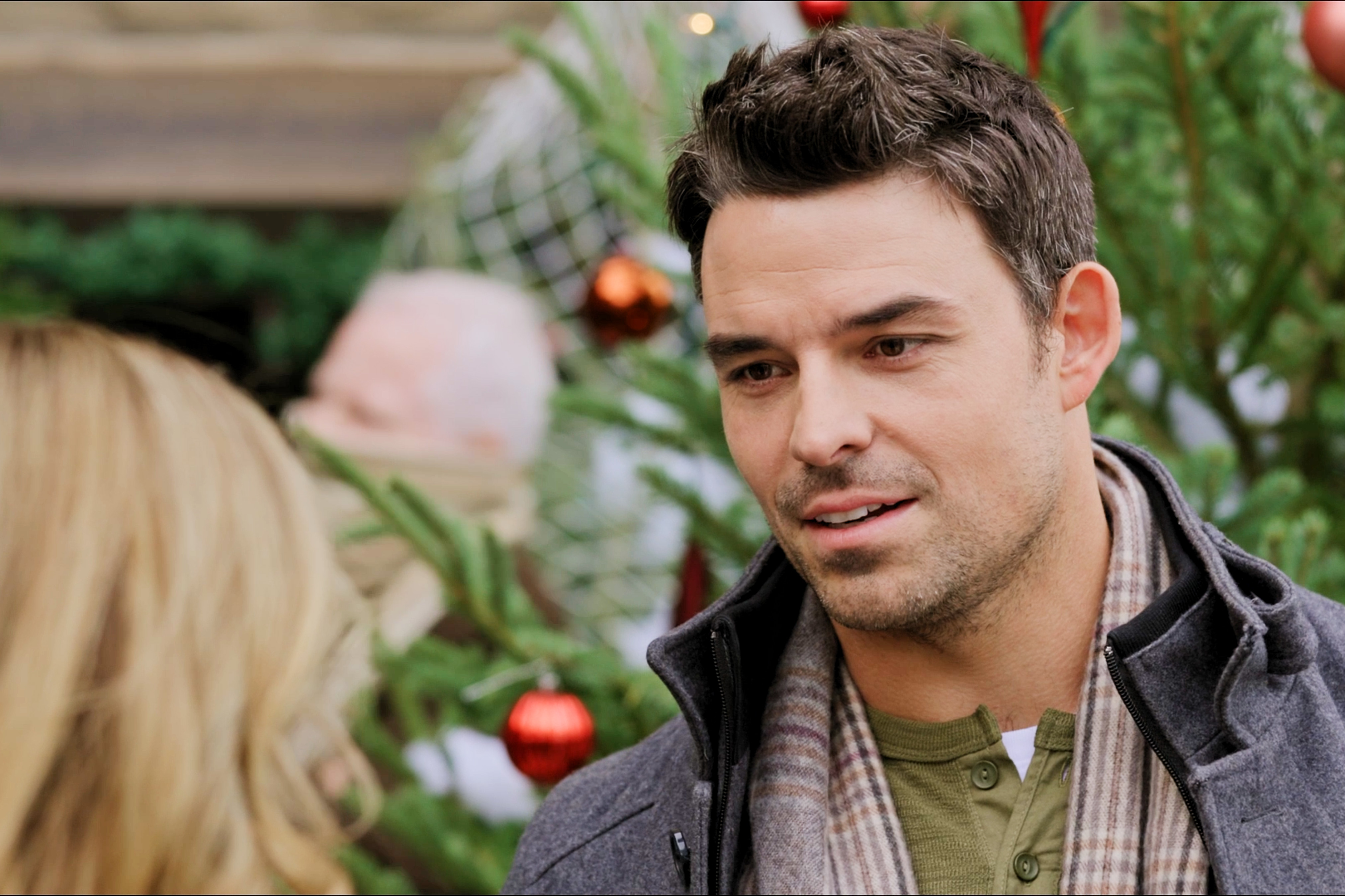 Jesse Hutch looking at a blonde woman in the Hallmark Channel movie 'Christmas in Toyland'