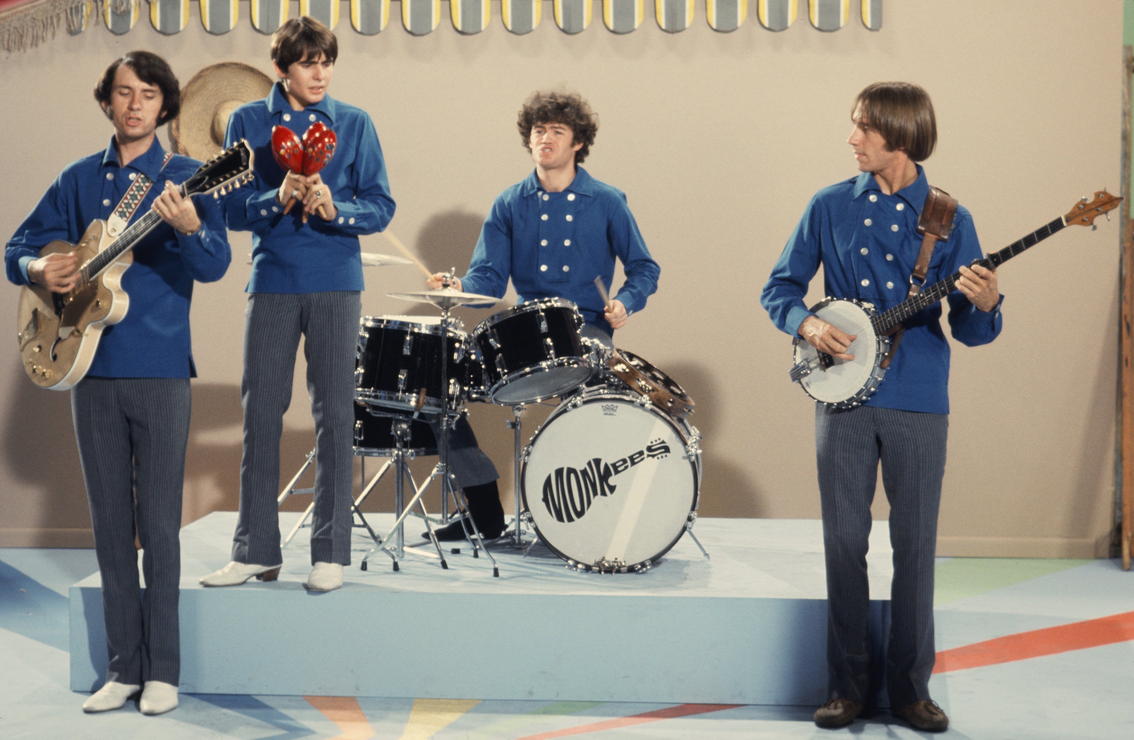 The Monkees' Mike Nesmith, Davy Jones, Micky Dolenz, and Peter Tork playing songs