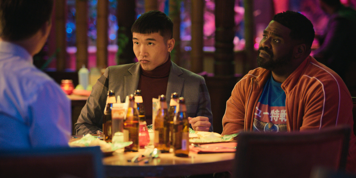 Joel Kim Booster and Ron Funches look on in 'Loot' Season 1 Episode 5: 'Halsa'