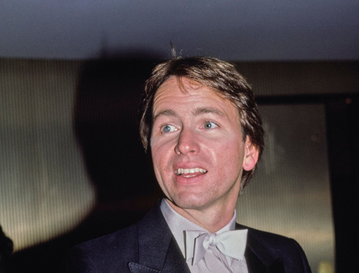 John Ritter smiling, looking off camera