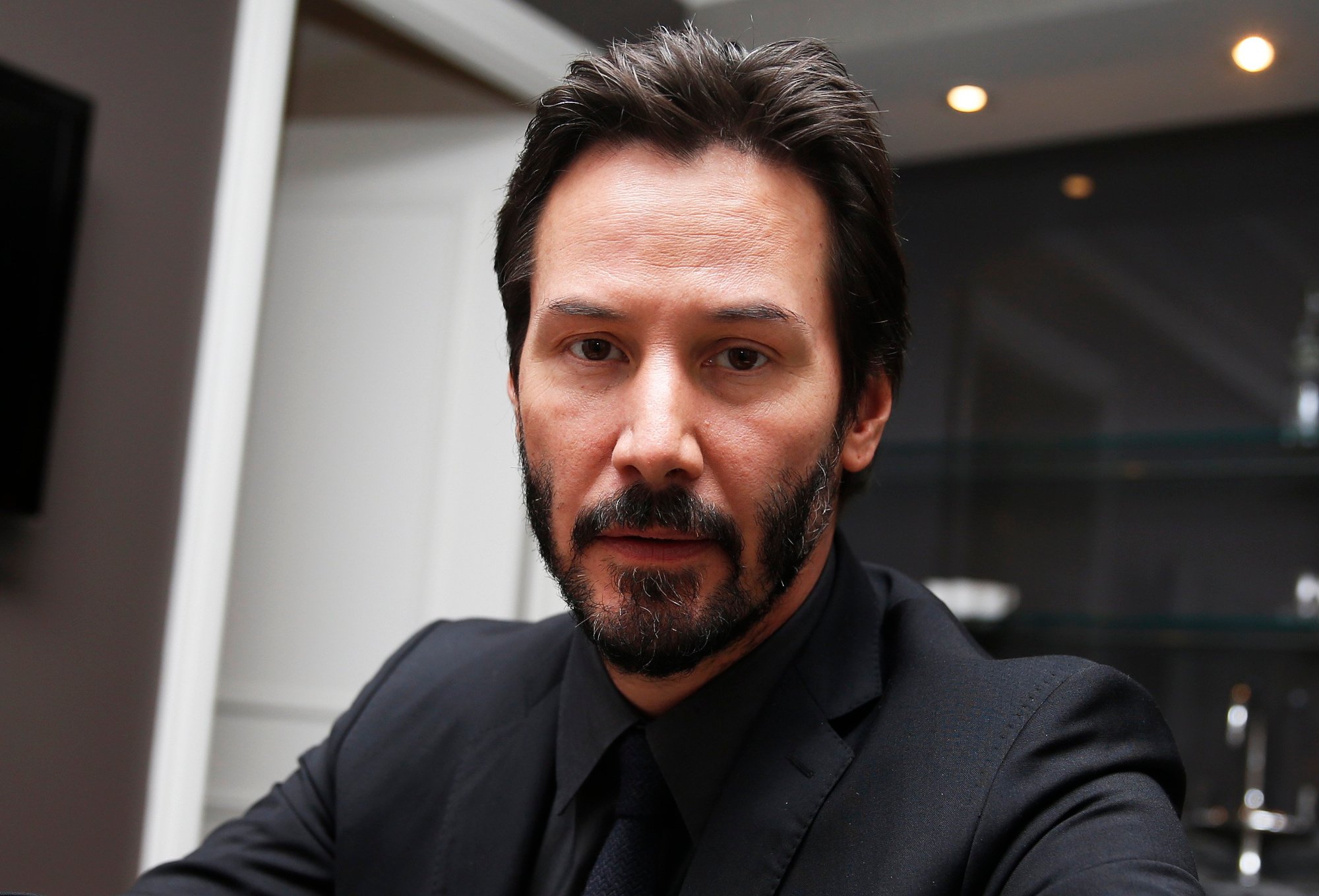 'John Wick' actor Keanu Reeves wearing a black suit