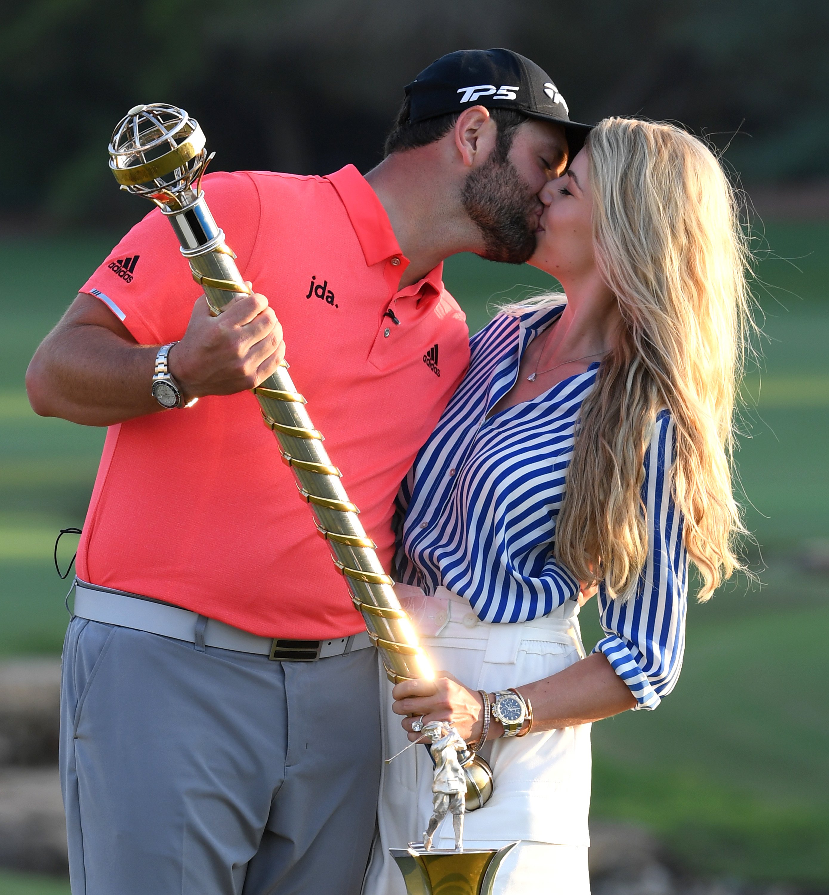 Jon Rahm and Kelley Cahill pose with the DP World Tour Championship trophy