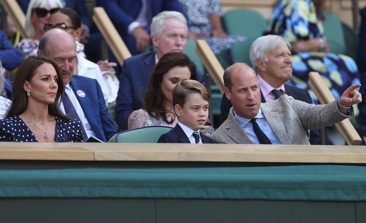 Kate Middleton and Prince William sit with Prince George at Wimbledon in what a body language expert calls a 'strategic move'