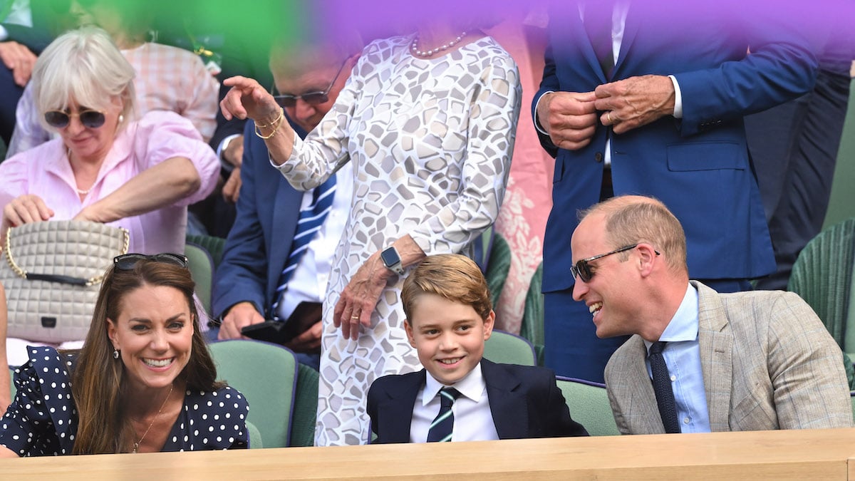 Kate Middleton, who had four words for why Prince George attended Wimbledon without Princess Charlotte, smiles as she sits next to Prince George and Prince William