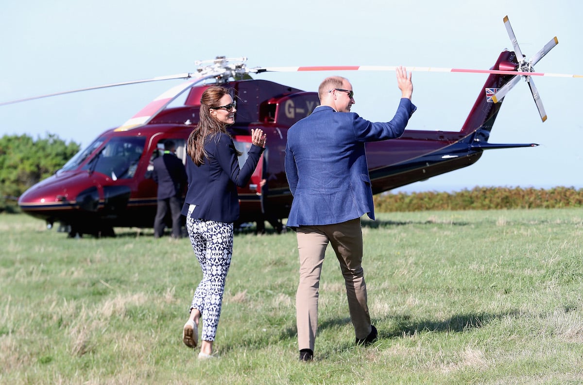 Kate Middleton and Prince William, who a royal expert says will likely be 'summoned' by Queen Elizabeth II for their helicopter use, board a helicopter