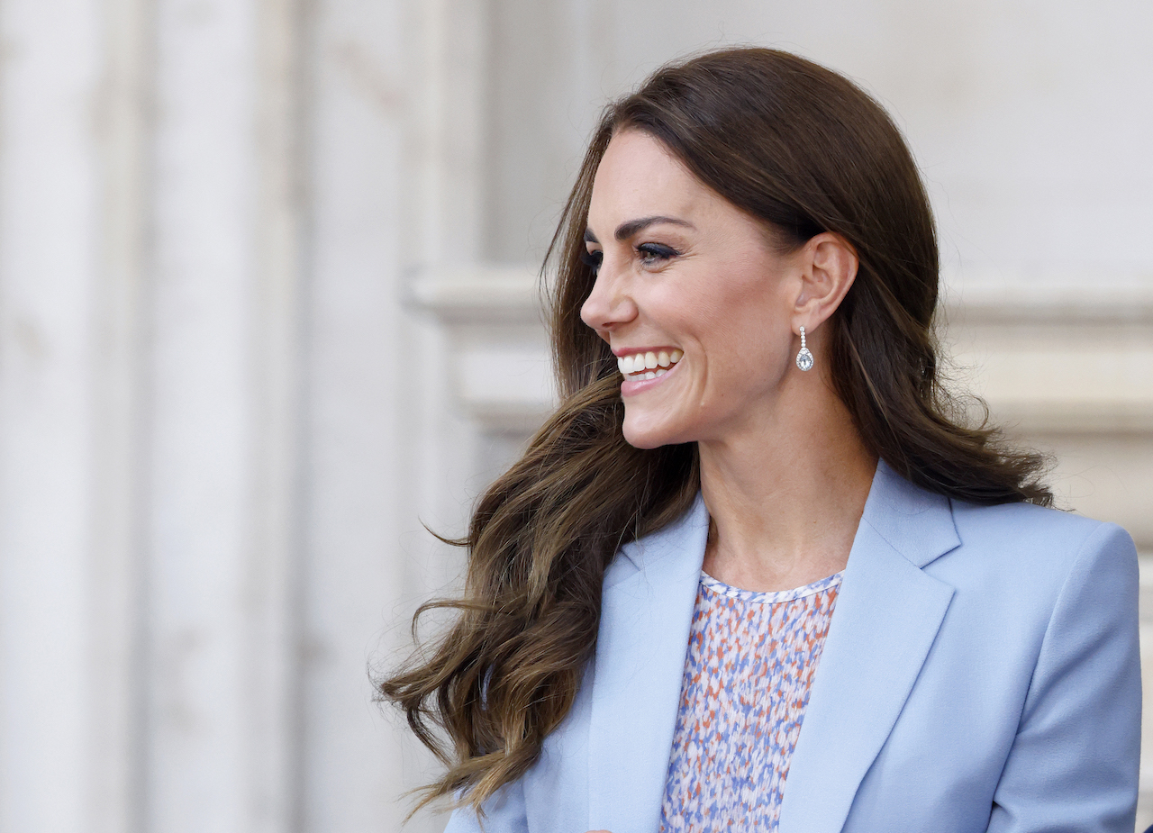 Kate Middleton, pictured in a floral dress and blue blazer, wears certain colors when she's the center of attention