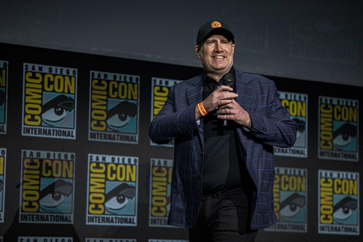 Kevin Feige smiling while holding a microphone.