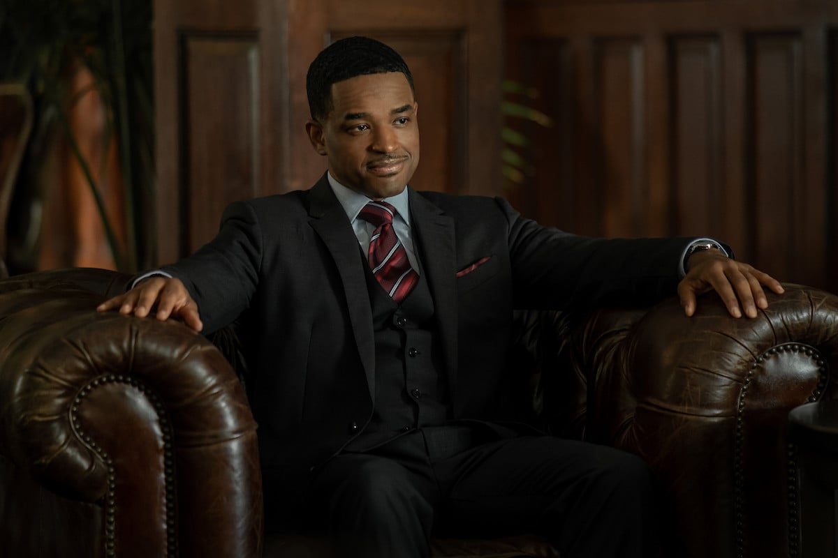 Larenz Tate as Rashad Tate sitting in a leather chair wearing a suit in 'Power Book II: Ghost