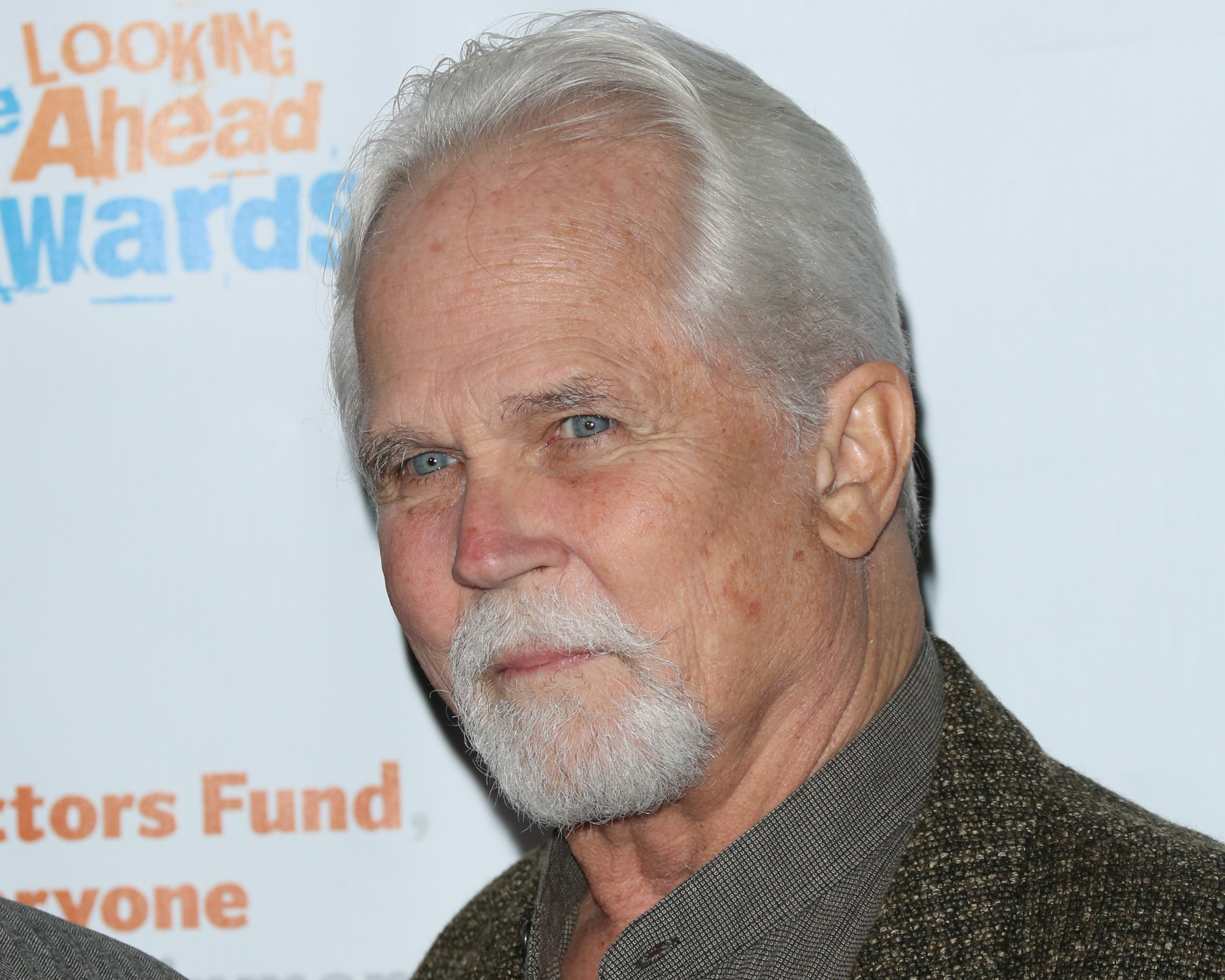 'Leave It to Beaver' actor Tony Dow, who has been declared dead at age 77. In the photo, he's smiling and wearing a dark green shirt and jacket.