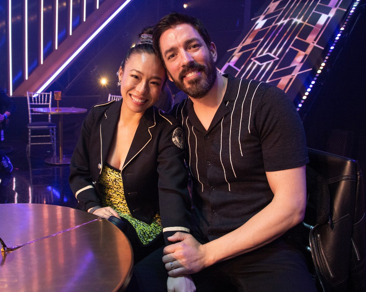 Linda Phan and Jonathan Scott sit next to each other and smile.