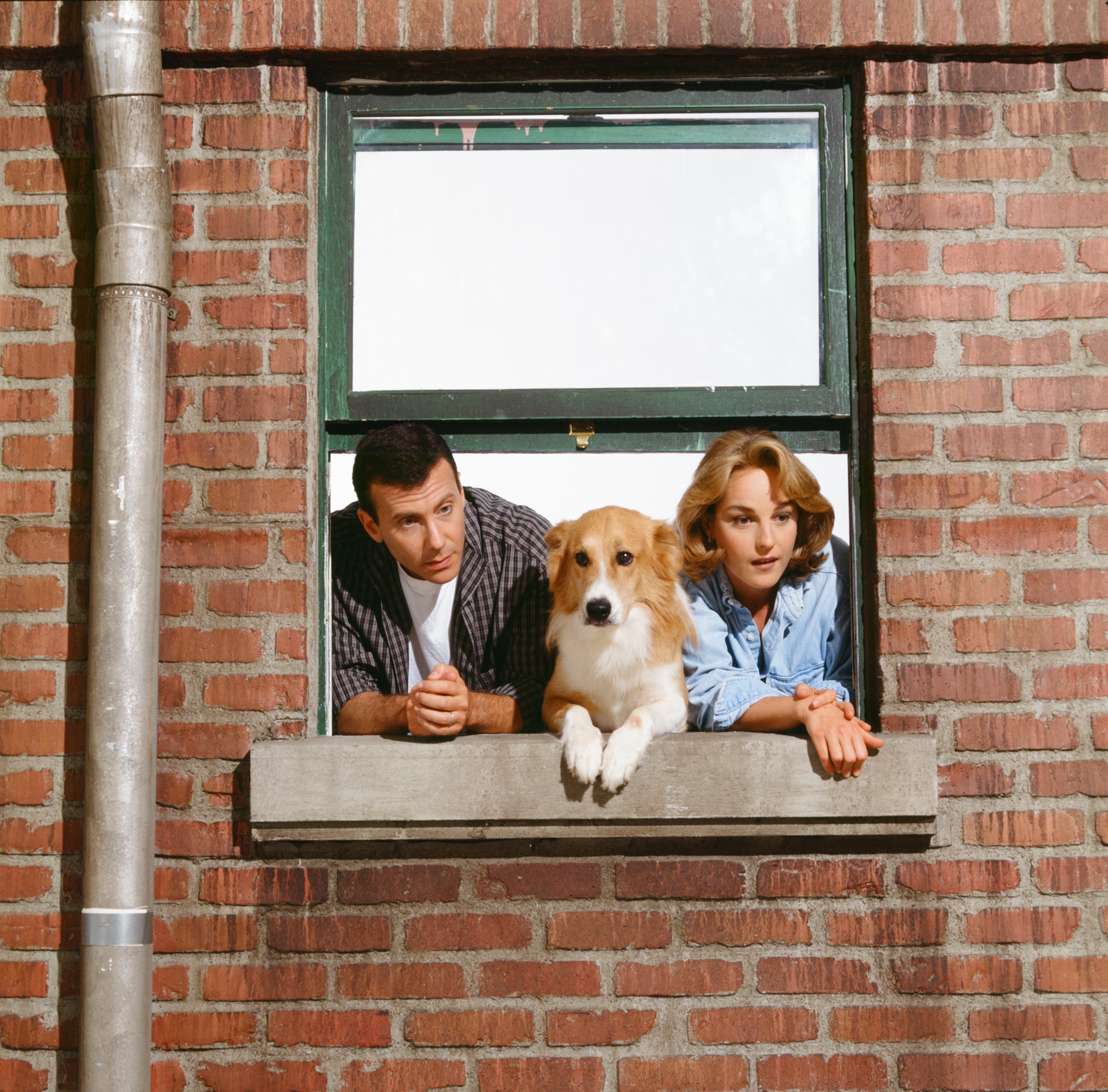 Paul, Murray and Jamie Buchman in the window of their apartment building for a promotional photo for 'Mad About You'