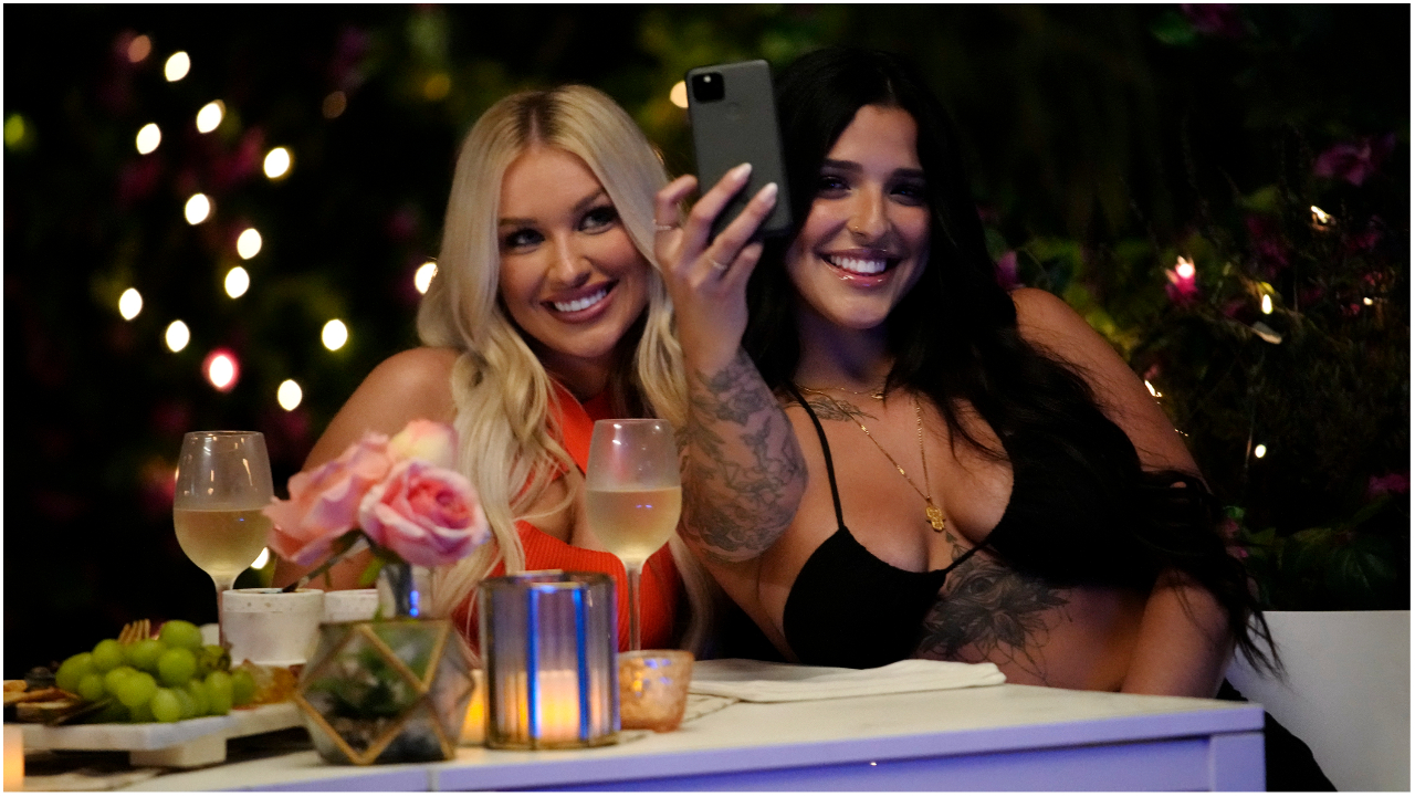 Mady McLanahan and Valerie Bragg sitting next to each during a dinner in 'Love Island: USA' Season 4