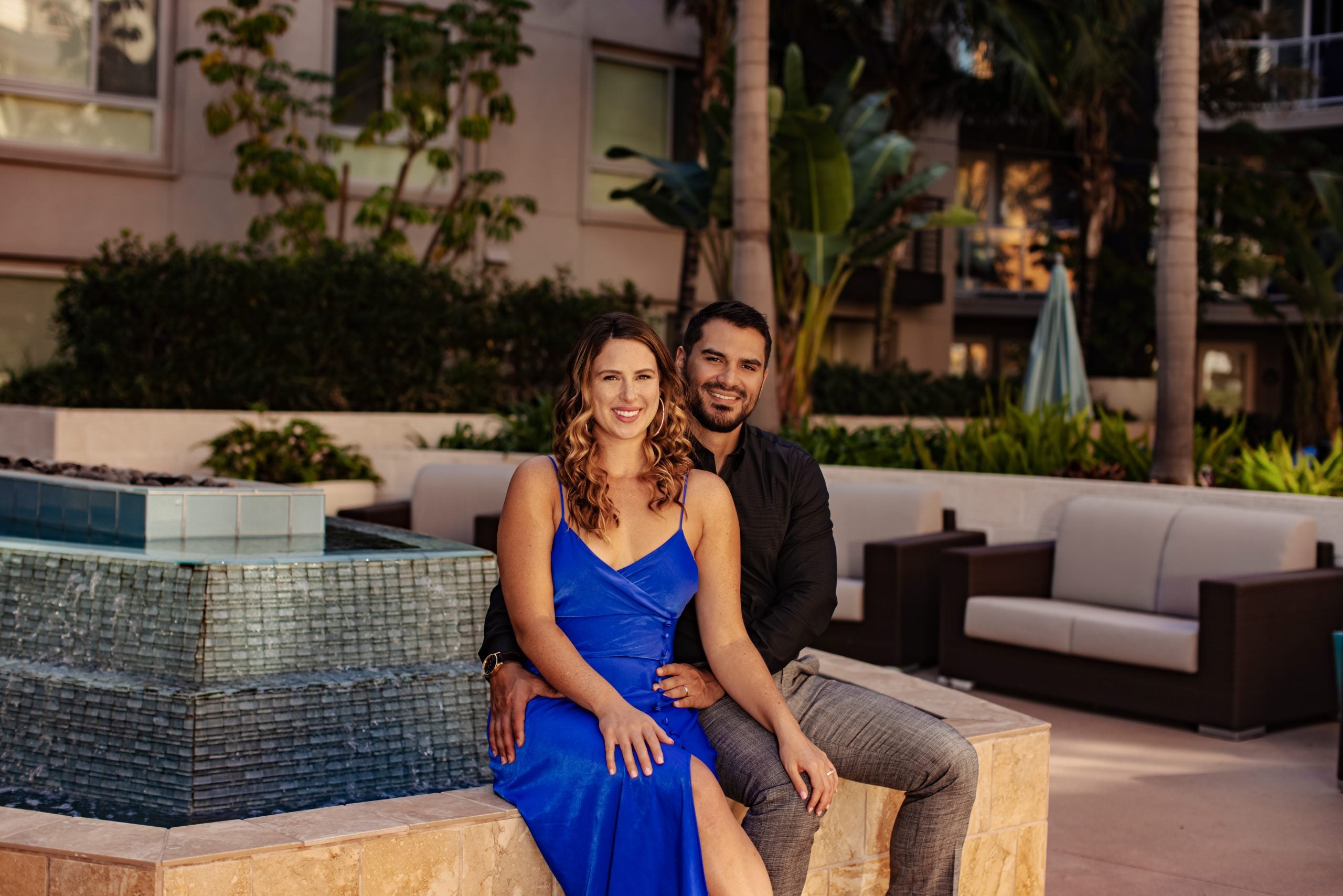 Lindy, in a blue dress, sitting in front of Miguel in promo shot for 'Married at First Sight' Season 15