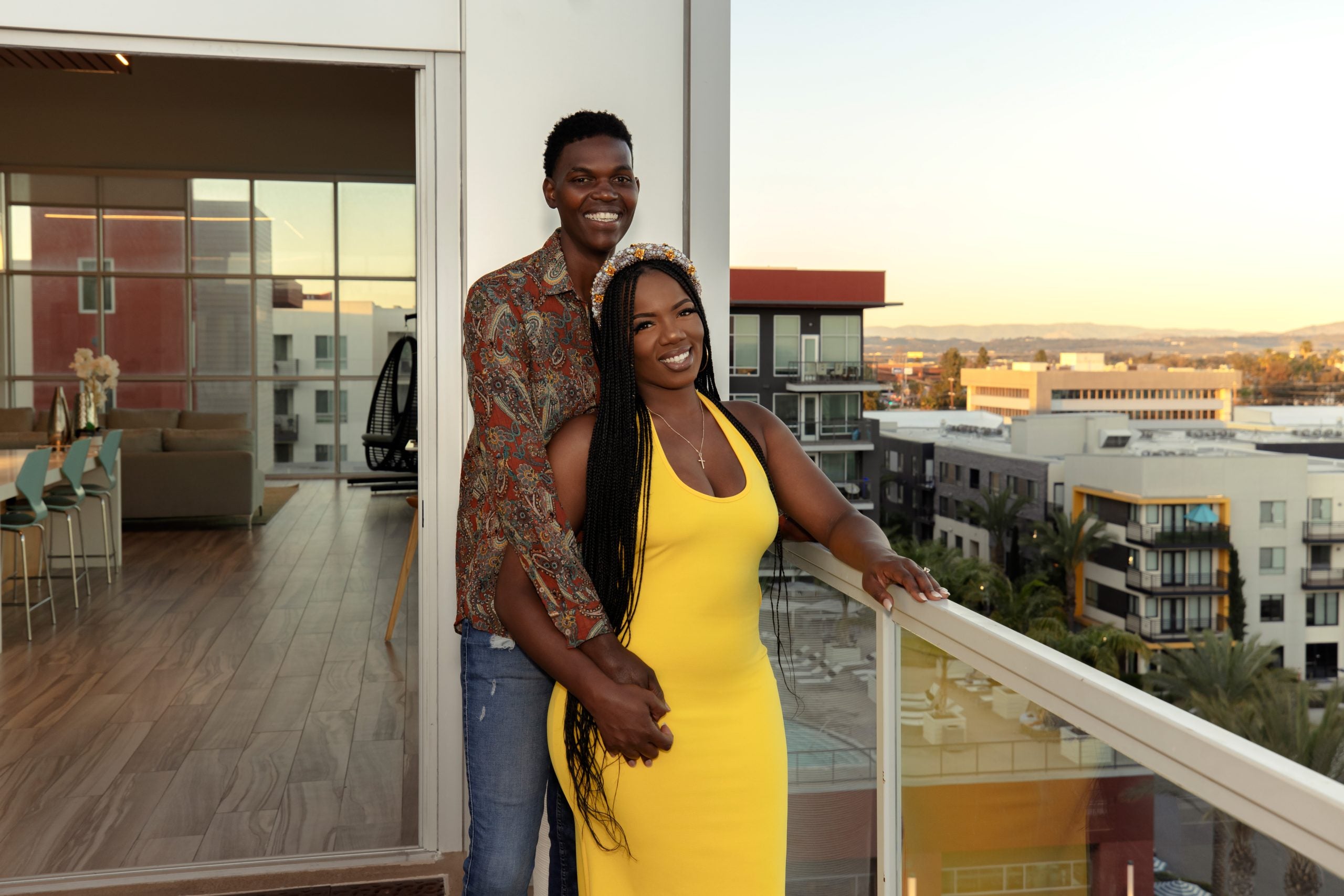 Justin with his arms around Alexis, who is wearing a yellow dress, in a promotional shot for 'Married at First Sight' Season 15