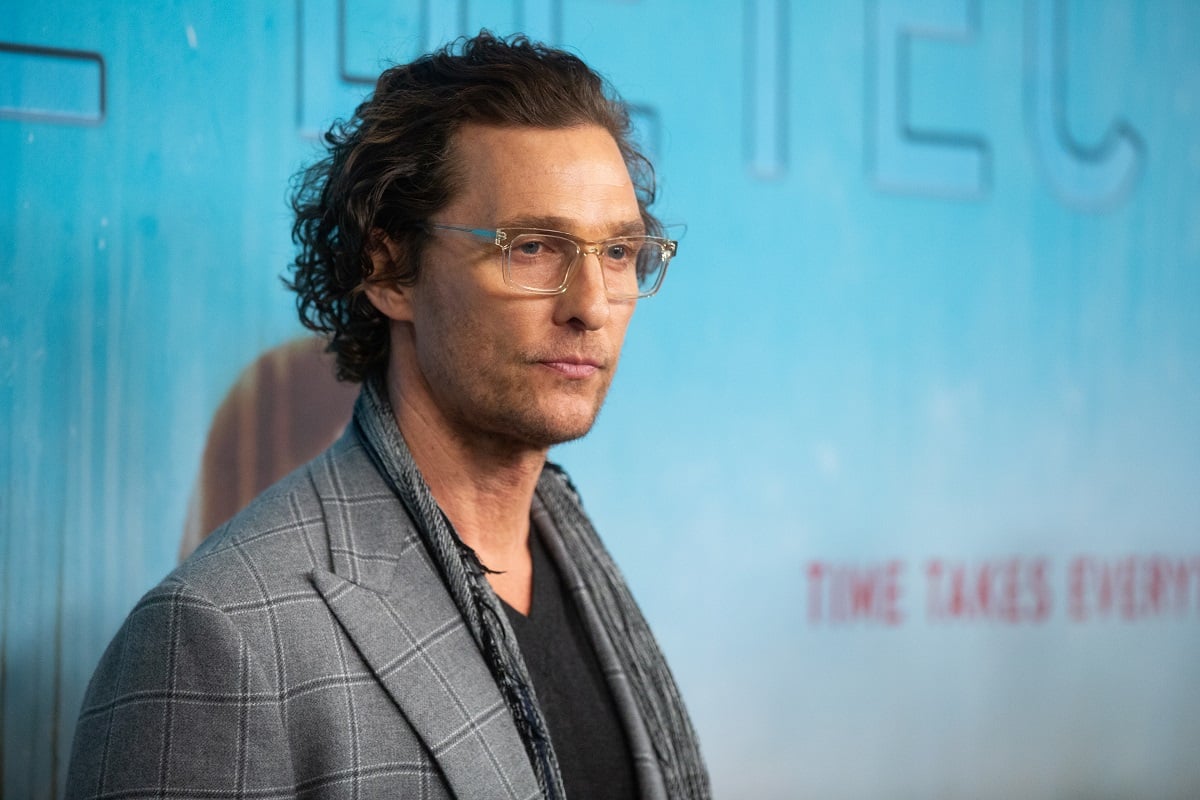 Matthew McConaughey posing while wearing a grey blazer.
