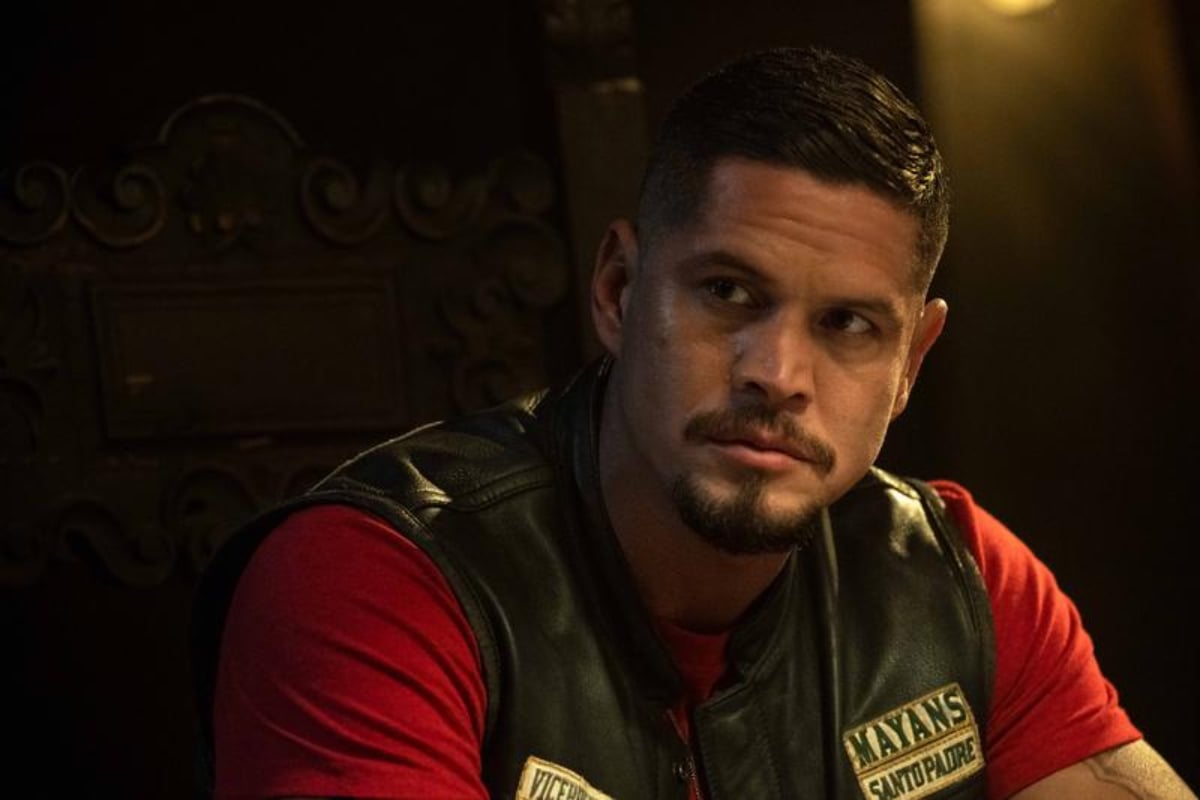 Mayans MC has been renewed for season 5. EZ Reyes wears his kutte over a red shirt.
