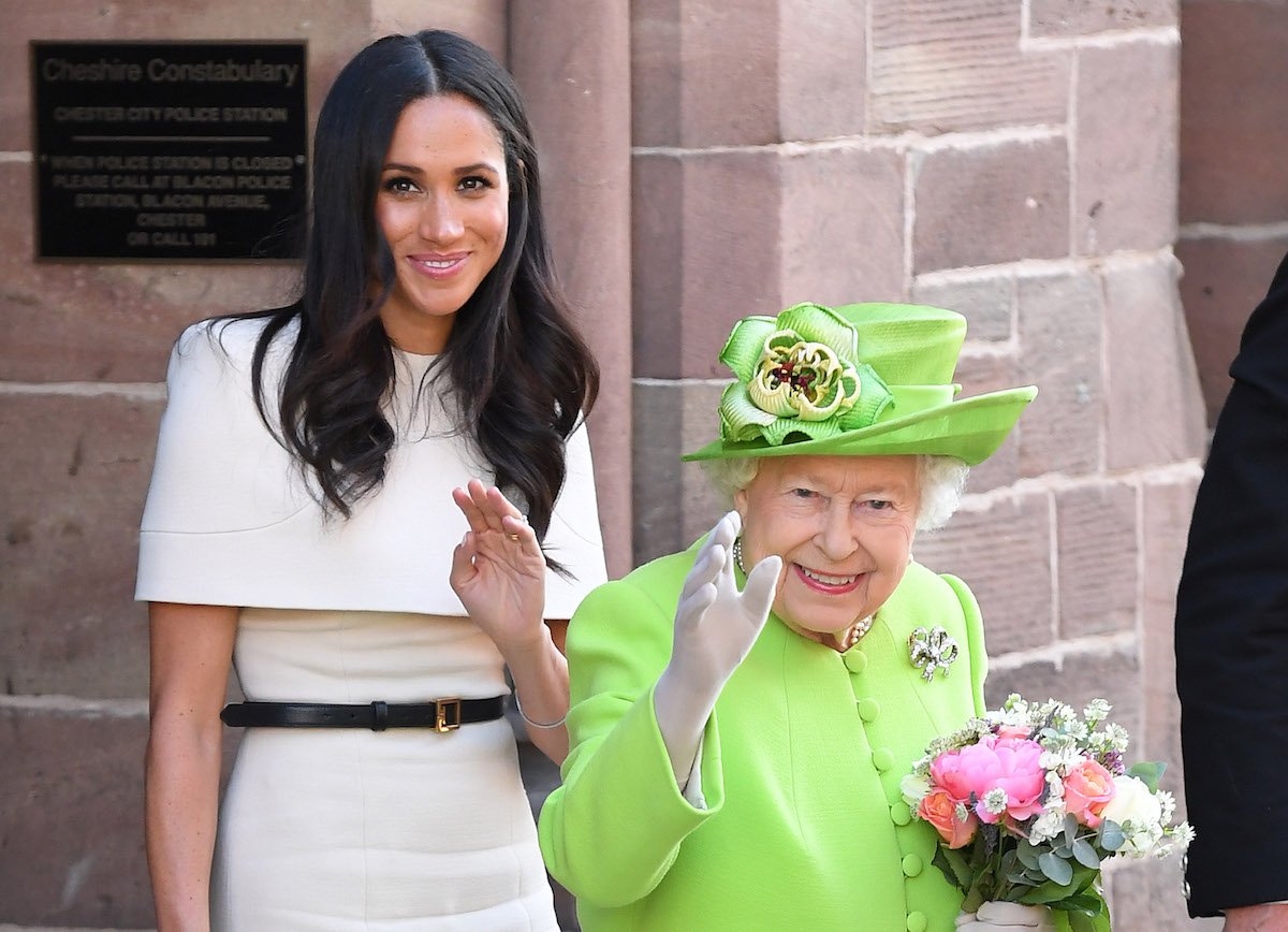 Meghan Markle and Queen Elizabeth II wave for the camera.