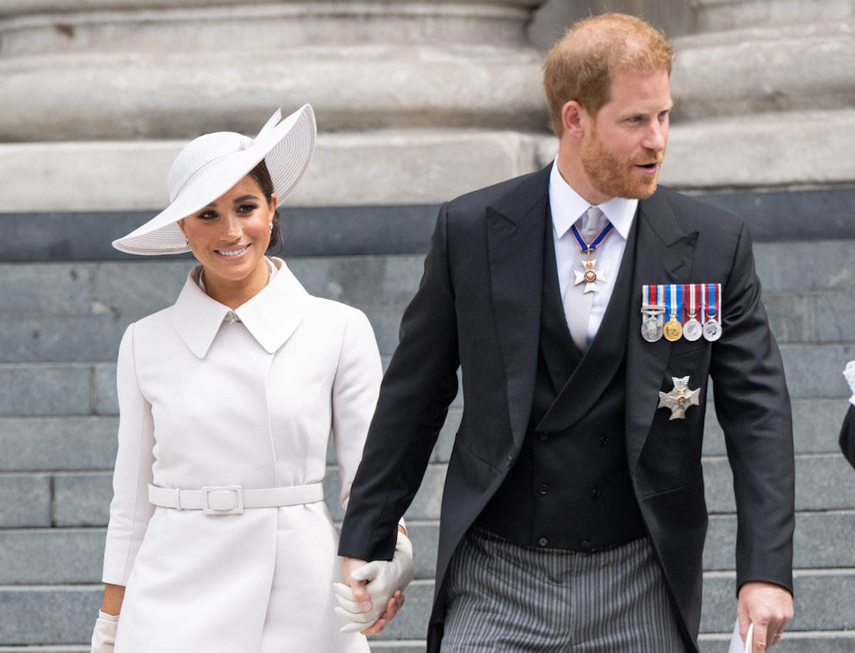 Meghan Markle, who hinted at a trip to Washington, D.C., with Gloria Steinem, stands withand Prince Harry