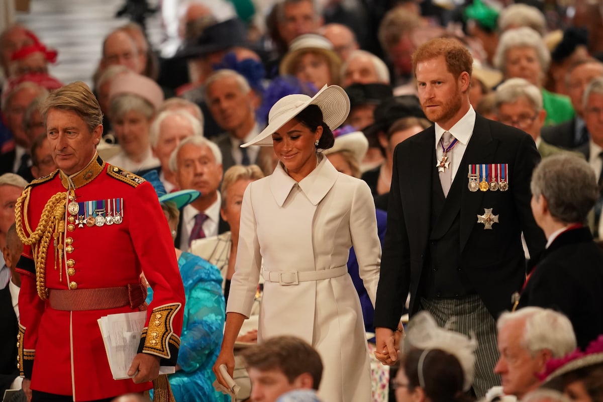 Meghan Markle and Prince Harry walk to their second row seats at a national service of thanksgiving during platinum jubilee weekend