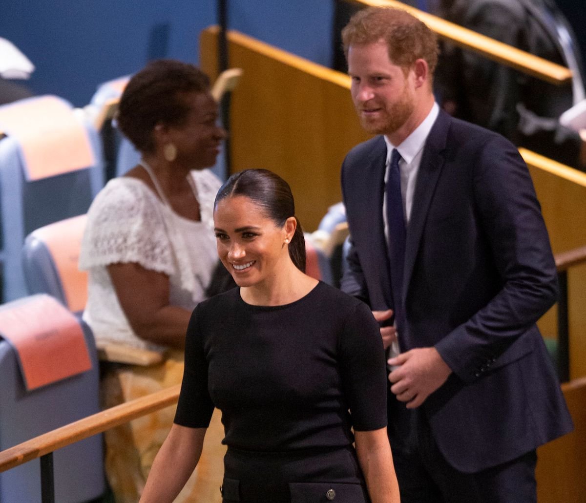 Meghan Markle, who Tom Bower says Prince Harry saw Princess Diana 'magic' in, walks in front of Prince Harry