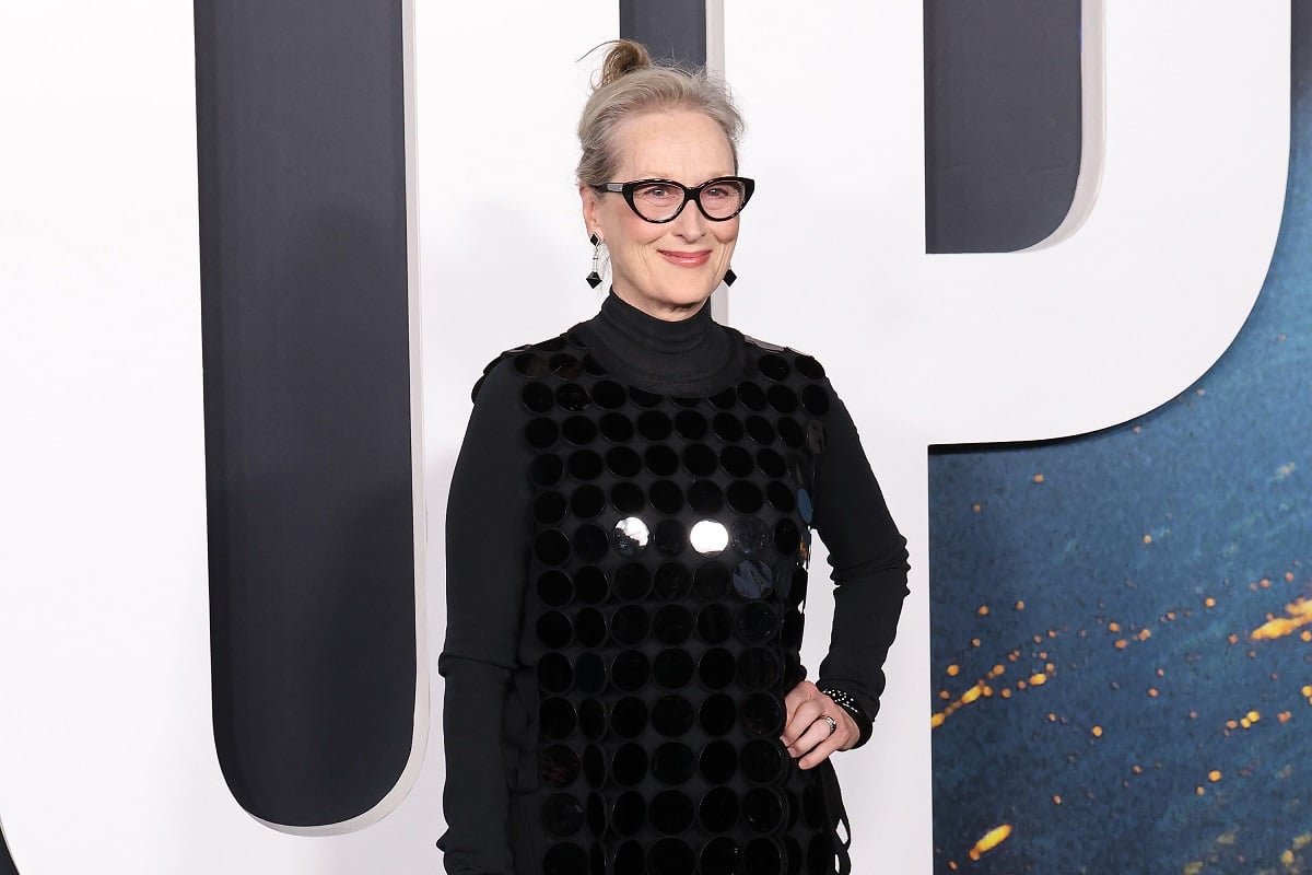 Meryl Streep smiling while wearing a black dress.
