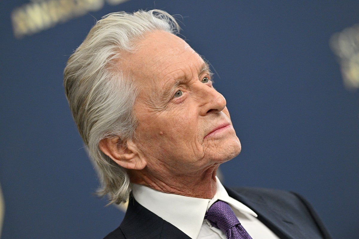 Michael Douglas posing while wearing a suit.