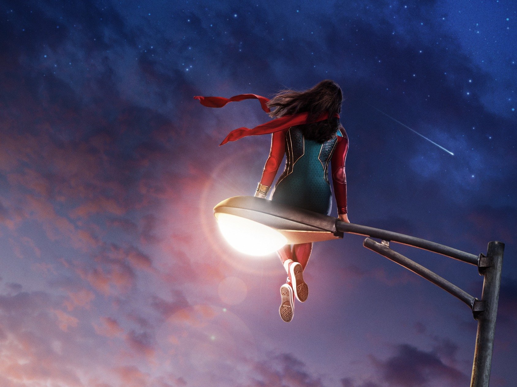 Key art for 'Ms. Marvel,' which has yet to be renewed for season 2. It shows Kamala Khan sitting on a street lamp and staring out at the cityscape.