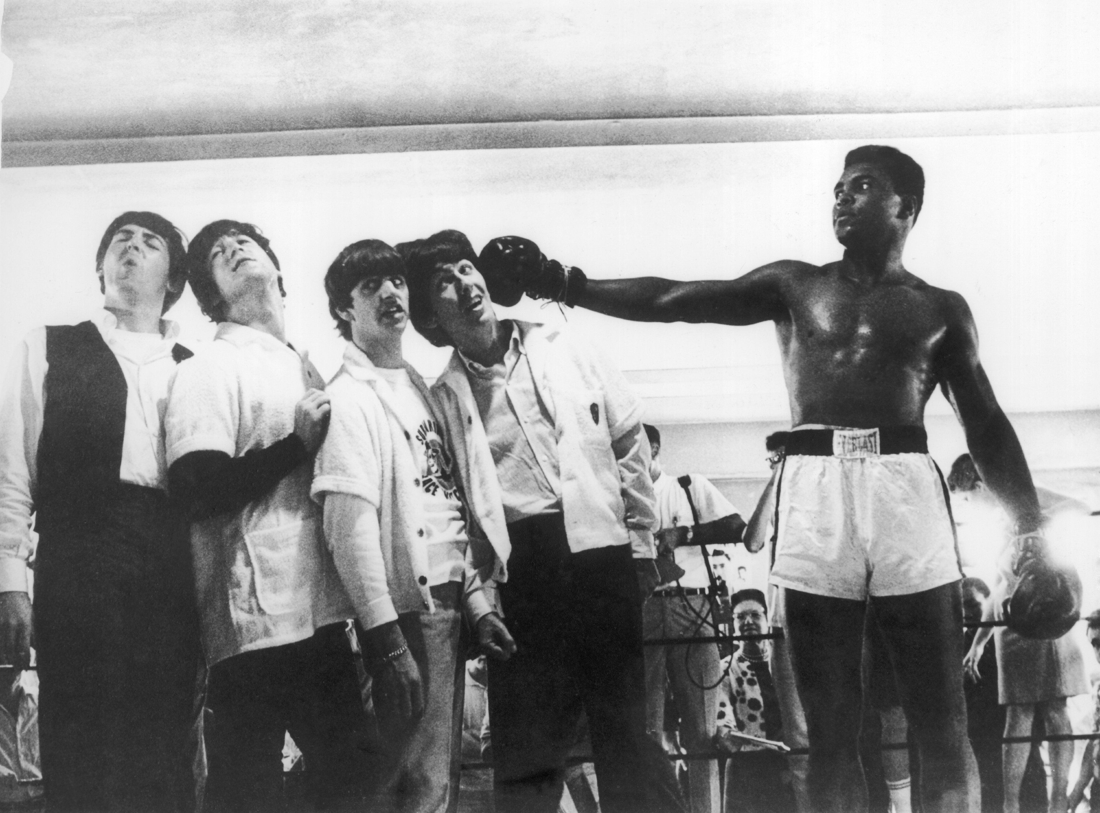Muhammad Ali pretending to punch The Beatles' Paul McCartney, John Lennon, Ringo Starr, and George Harrison