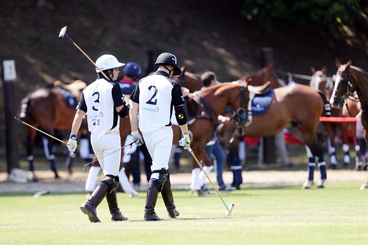 Nacho Figueras and Prince Harry walk out before the Sentebale ISPS Handa Polo Cup
