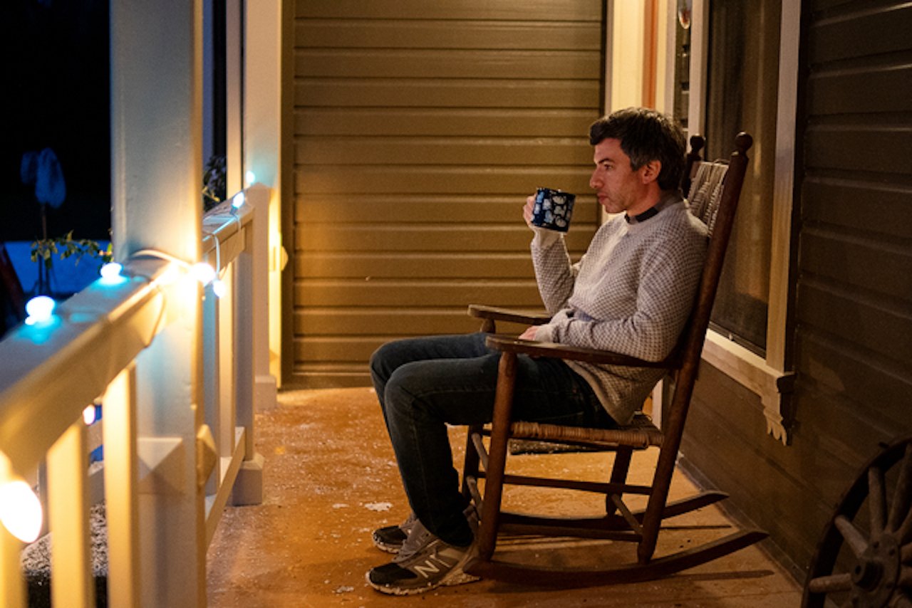 Nathan Fielder sitting in a rocking chair in 'The Rehearsal'