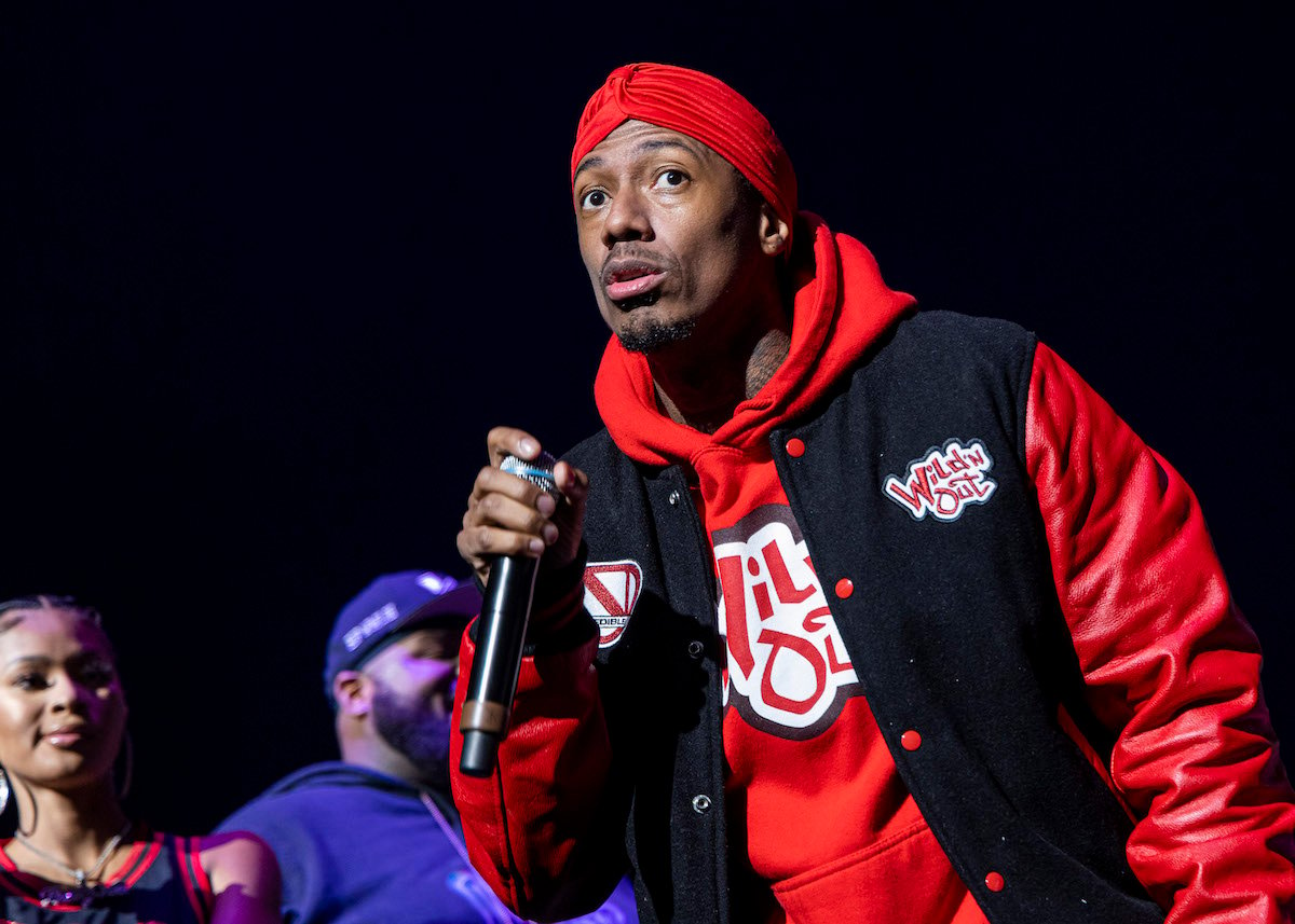 Nick Cannon, who pays child support for his eight children, on stage with a microphone.